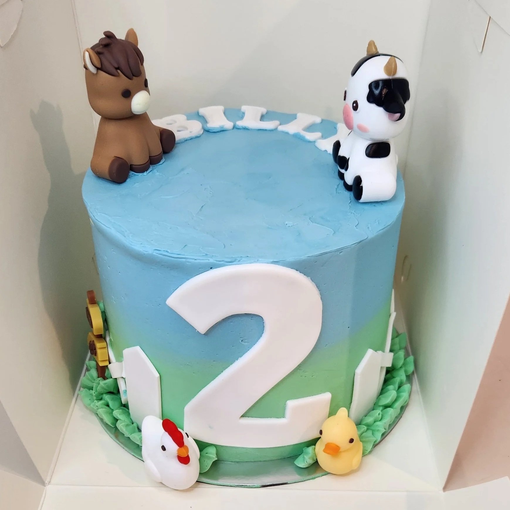 A cute farm-themed cake decorated in soft, natural tones with buttercream textures, fondant farm animals, and rustic details. Perfect for a fun, country-inspired birthday.