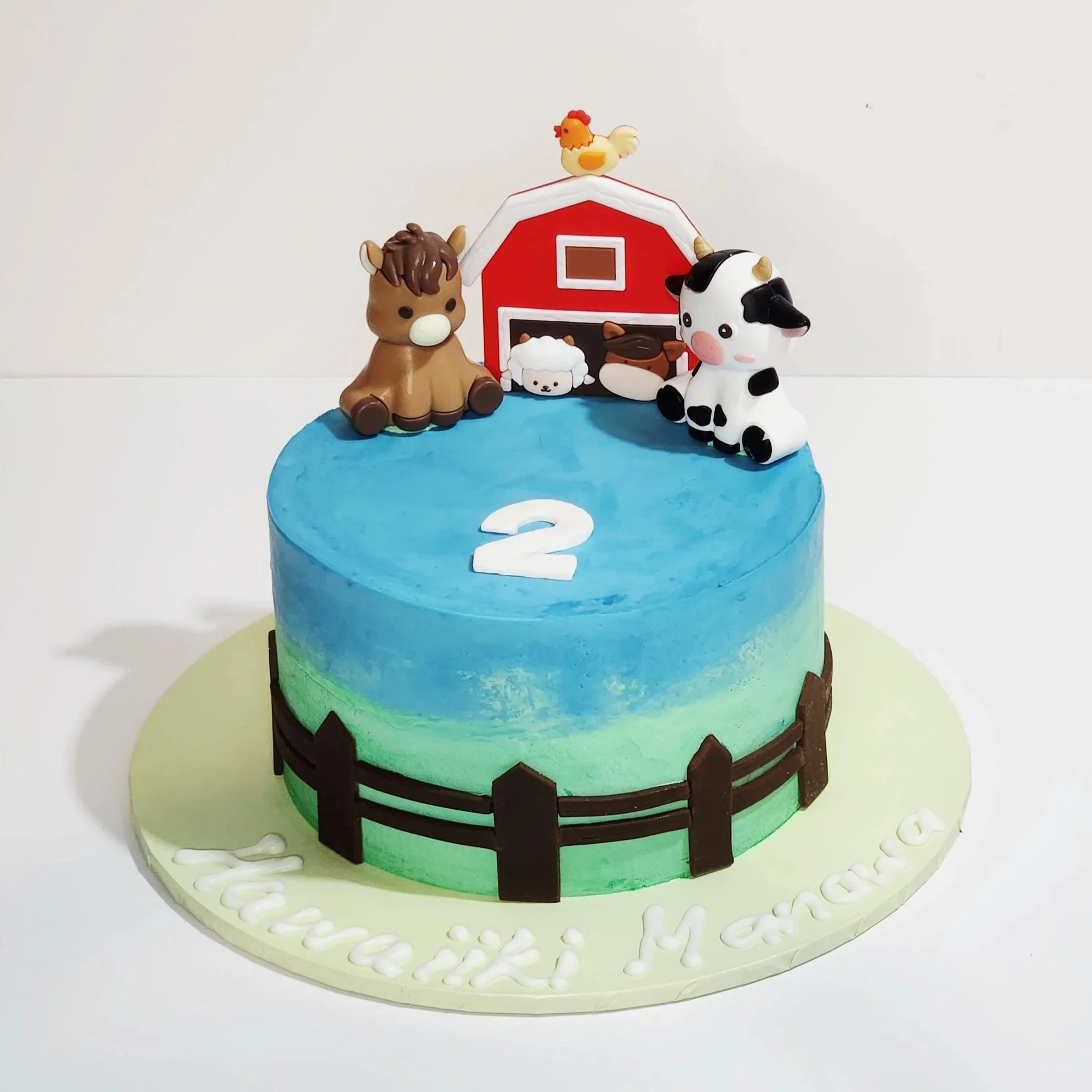A cute farm-themed cake decorated in soft, natural tones with buttercream textures, fondant farm animals, and rustic details. Perfect for a fun, country-inspired birthday.