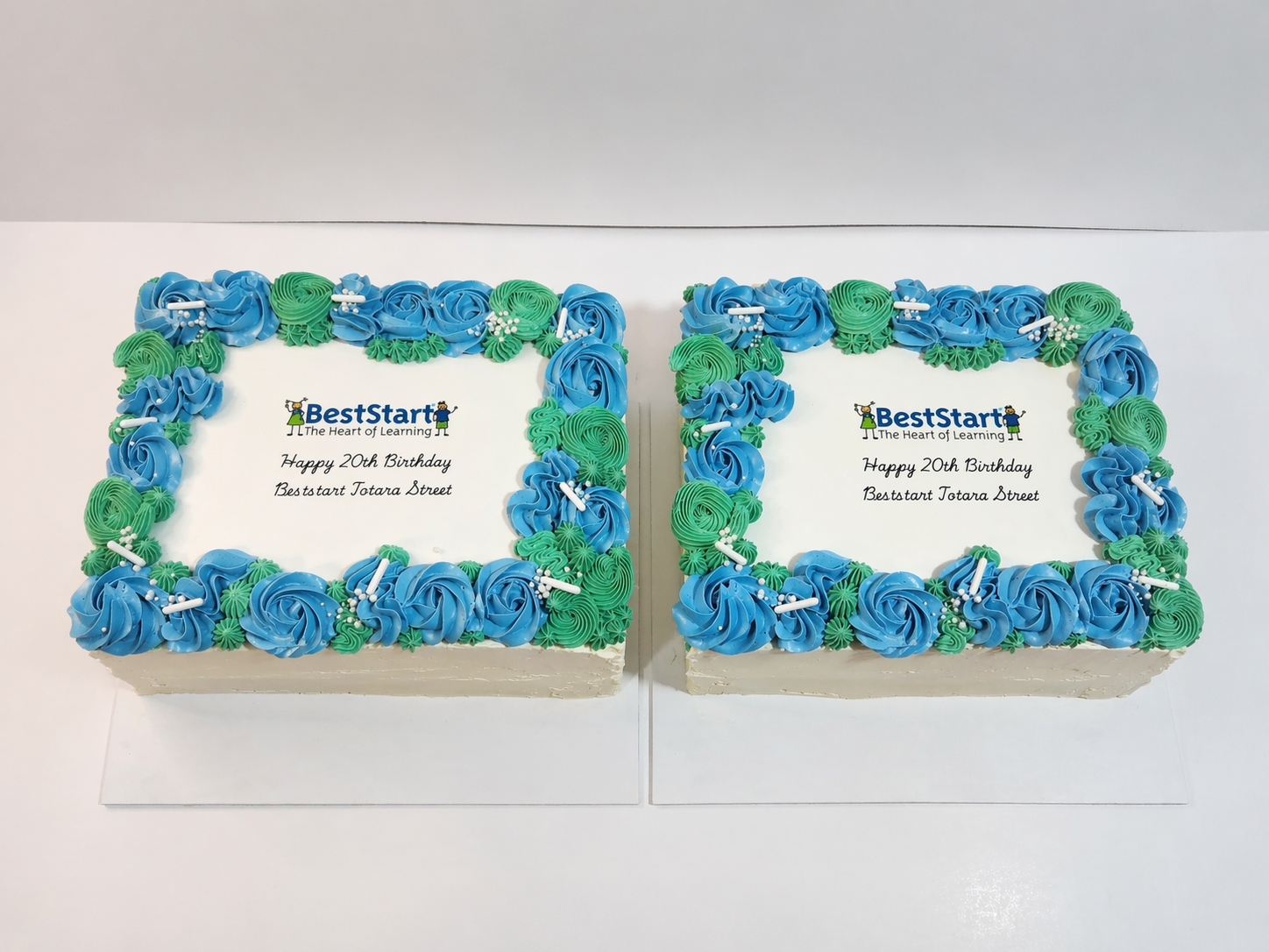 Make your next workplace milestone memorable with a professionally finished, custom-branded celebration cake. Designed with clean white icing and a striking piped buttercream border in your choice of colours, this cake features your company logo and 