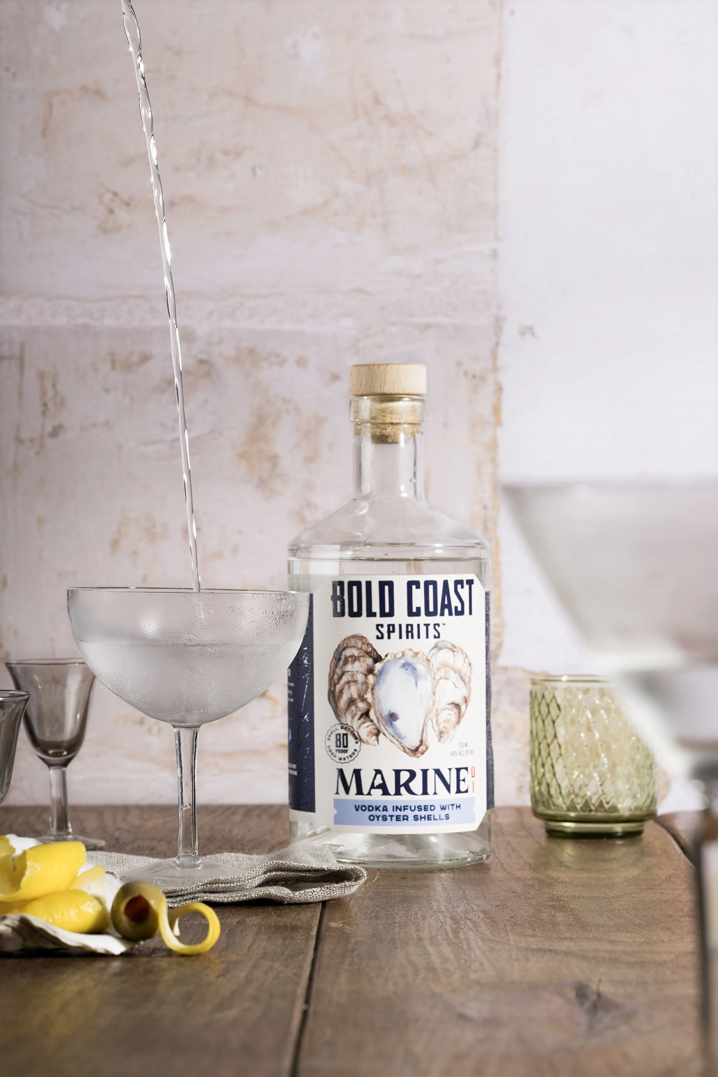 Oyster Vodka bottle beside a freshly poured martini