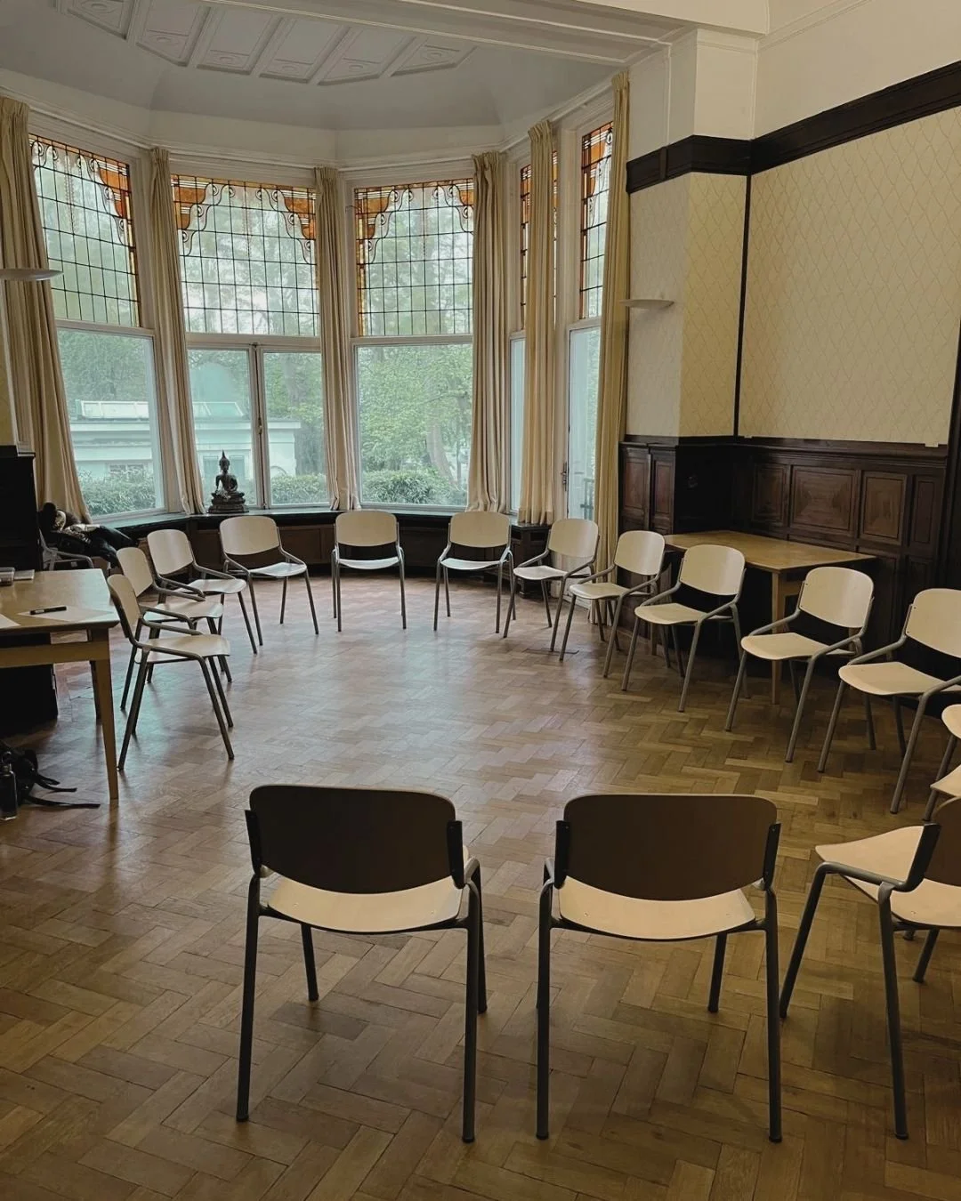 A room filled with empty chairs in a circle.