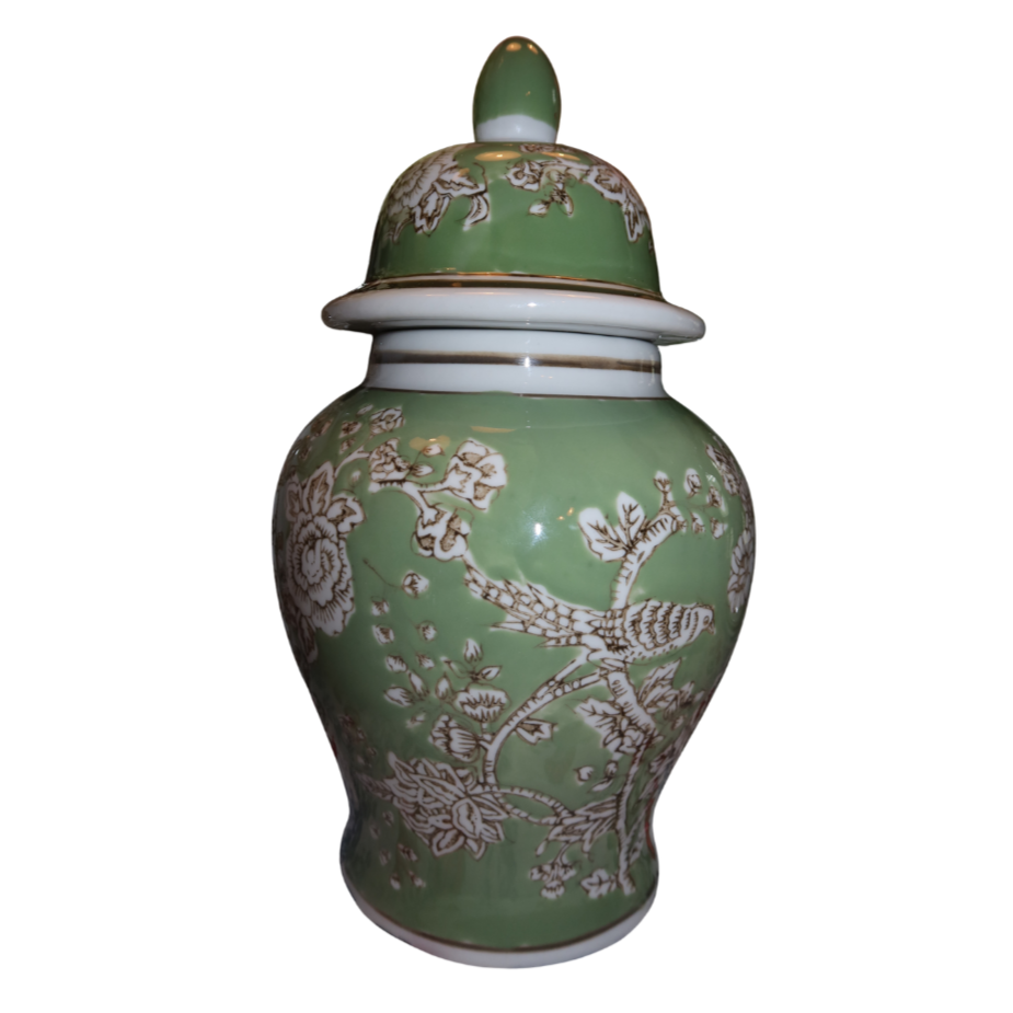 Green ceramic jar with a lid, decorated with white floral and bird patterns.