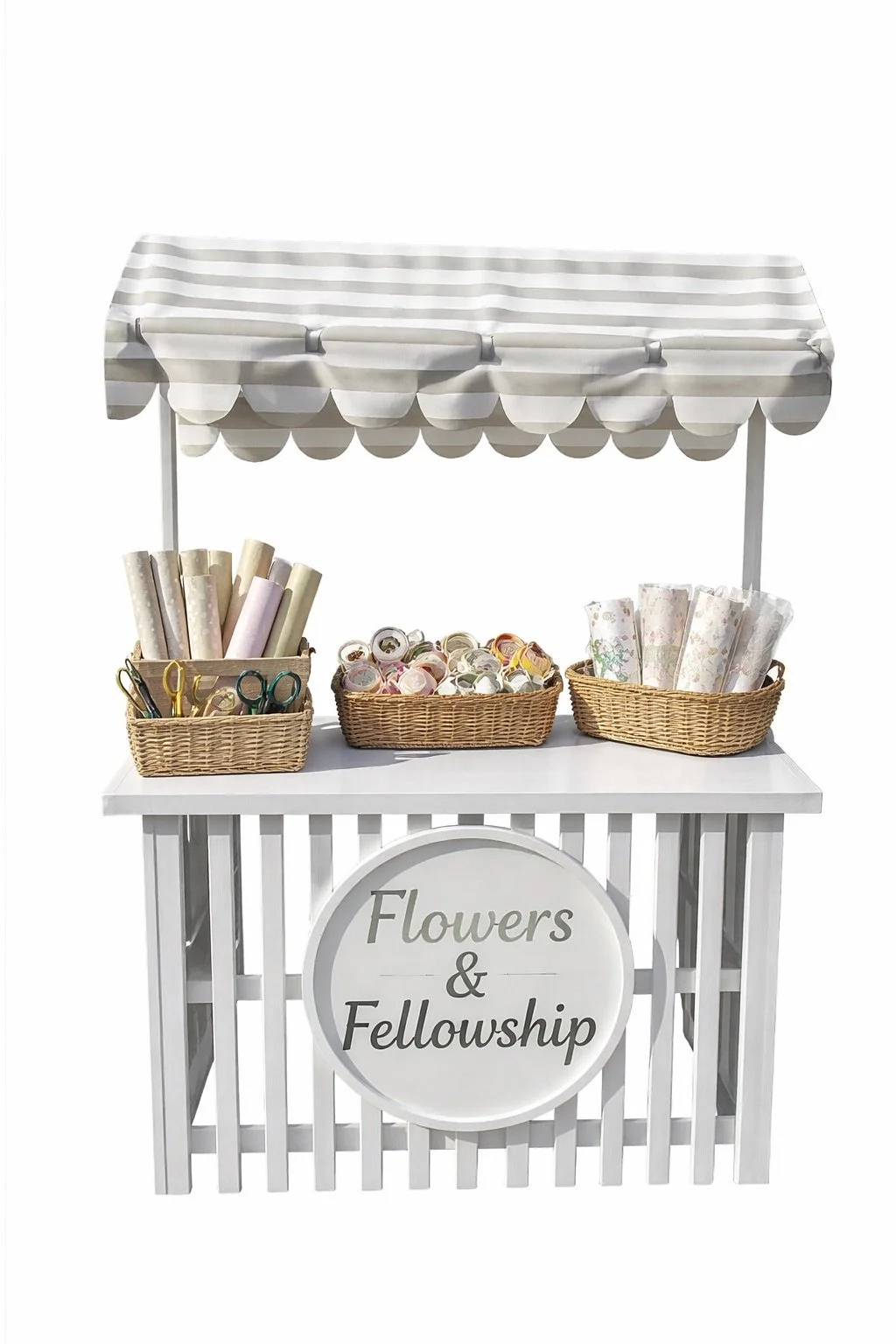A white flower and fellowship stand with a striped canopy, baskets of decorative rolls of paper, ribbons, and tape, and a round sign that reads "Flowers & Fellowship".