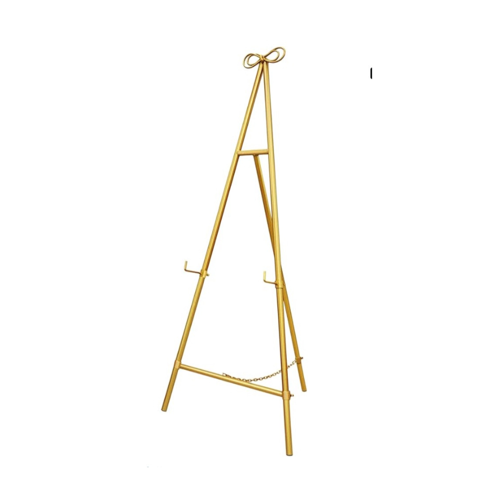 A gold-colored decorative easel with a ribbon tied at the top, standing on a white background.