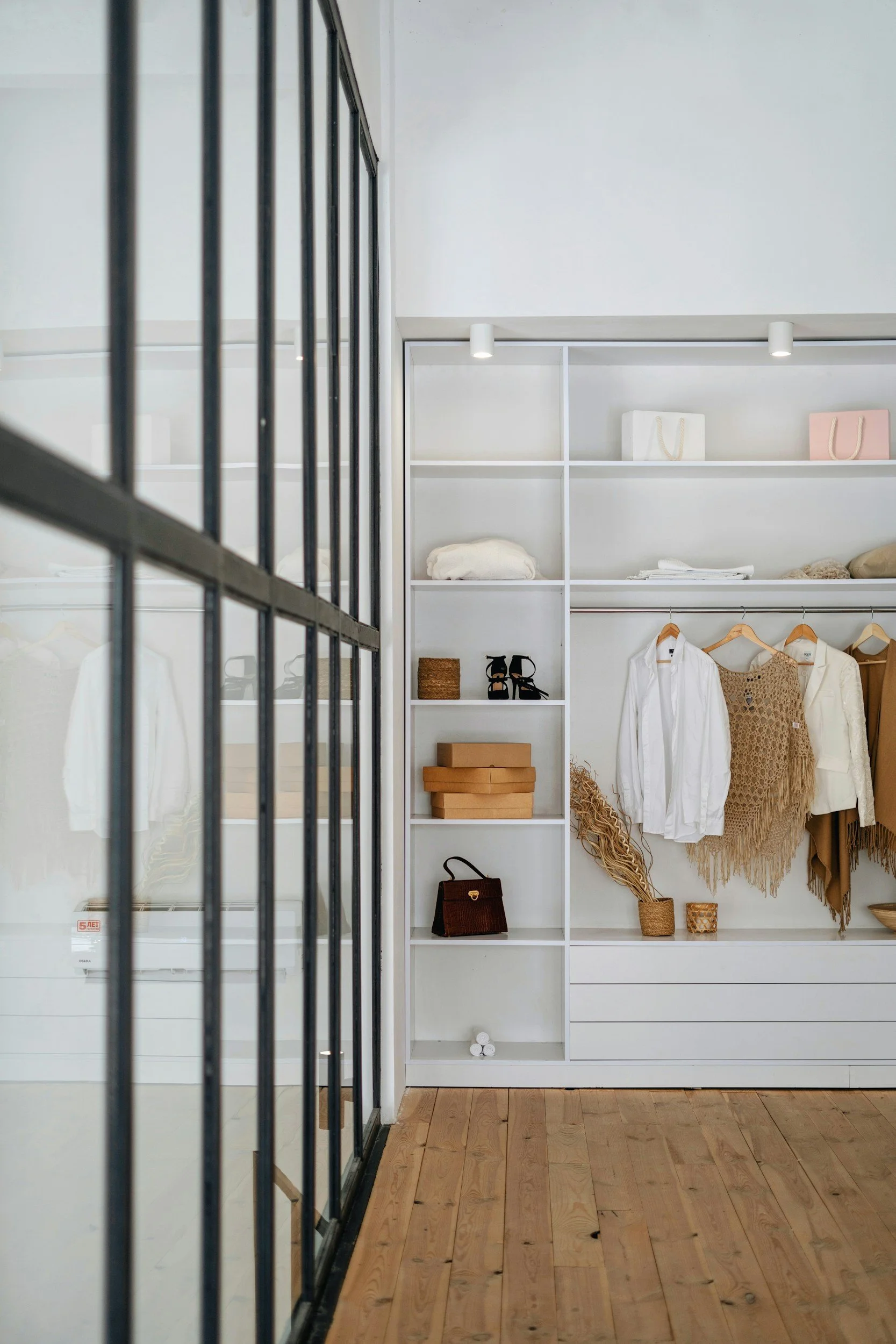 Closet with clothing, handbag, shoes, and accessories.
