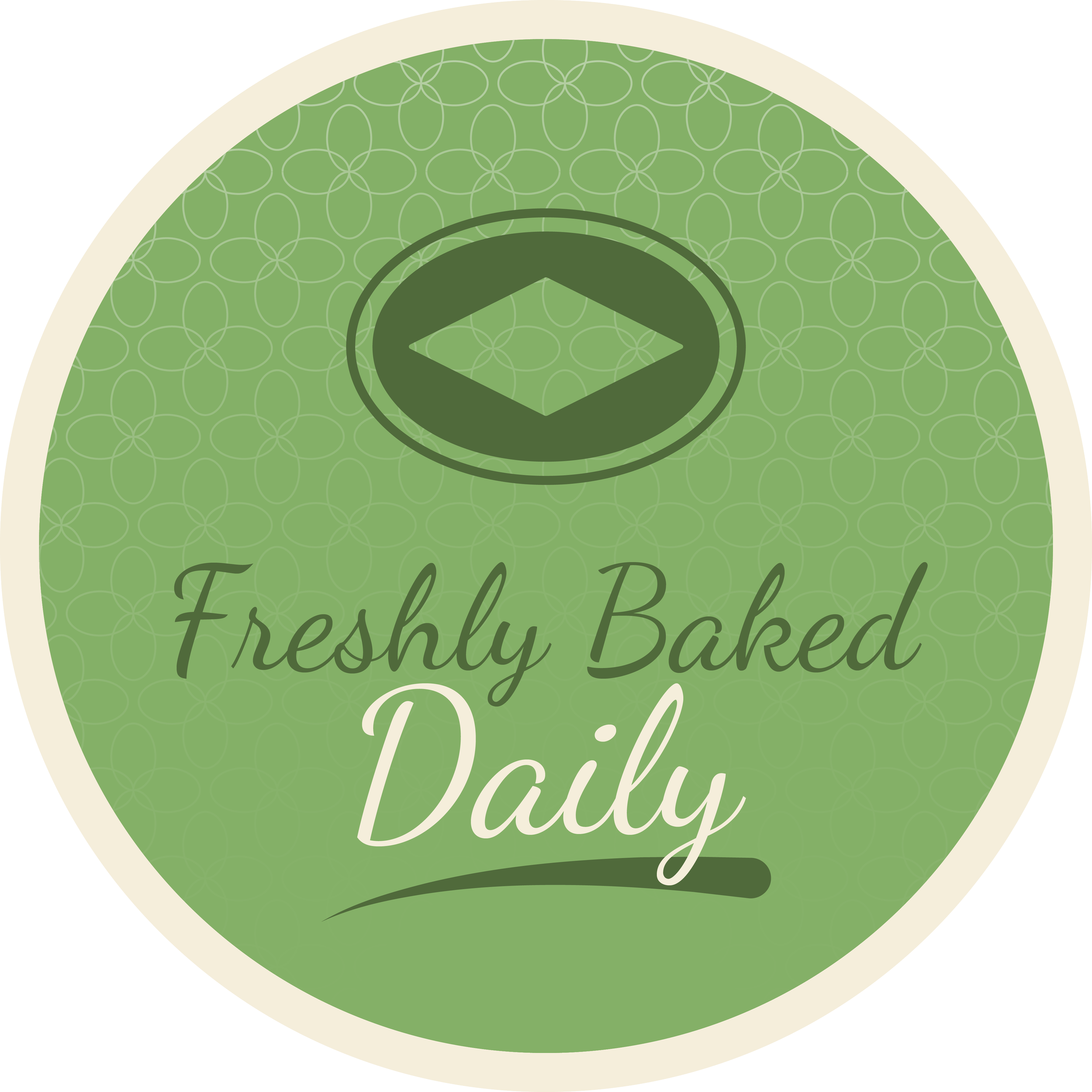 A circular green label with a darker green emblem at the top, and the text "Freshly Baked Daily" written in cursive font.
