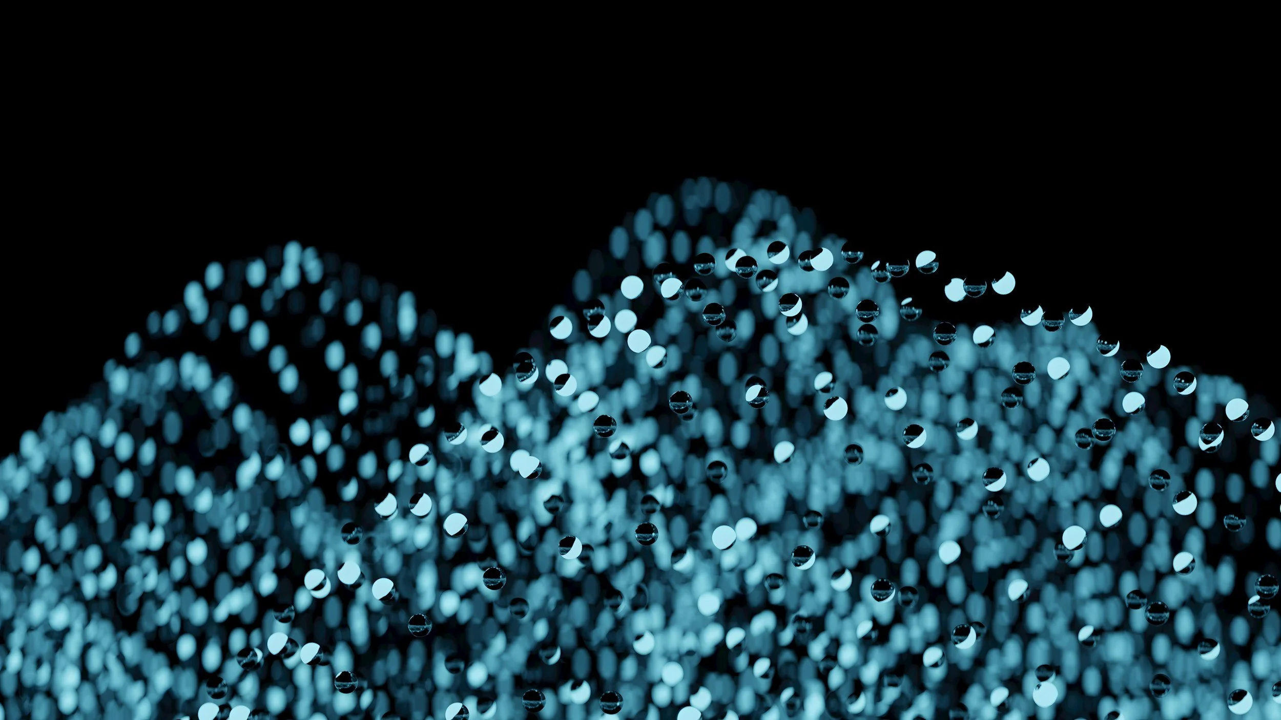 Close-up of blue LED lights creating a bokeh effect against a black background.