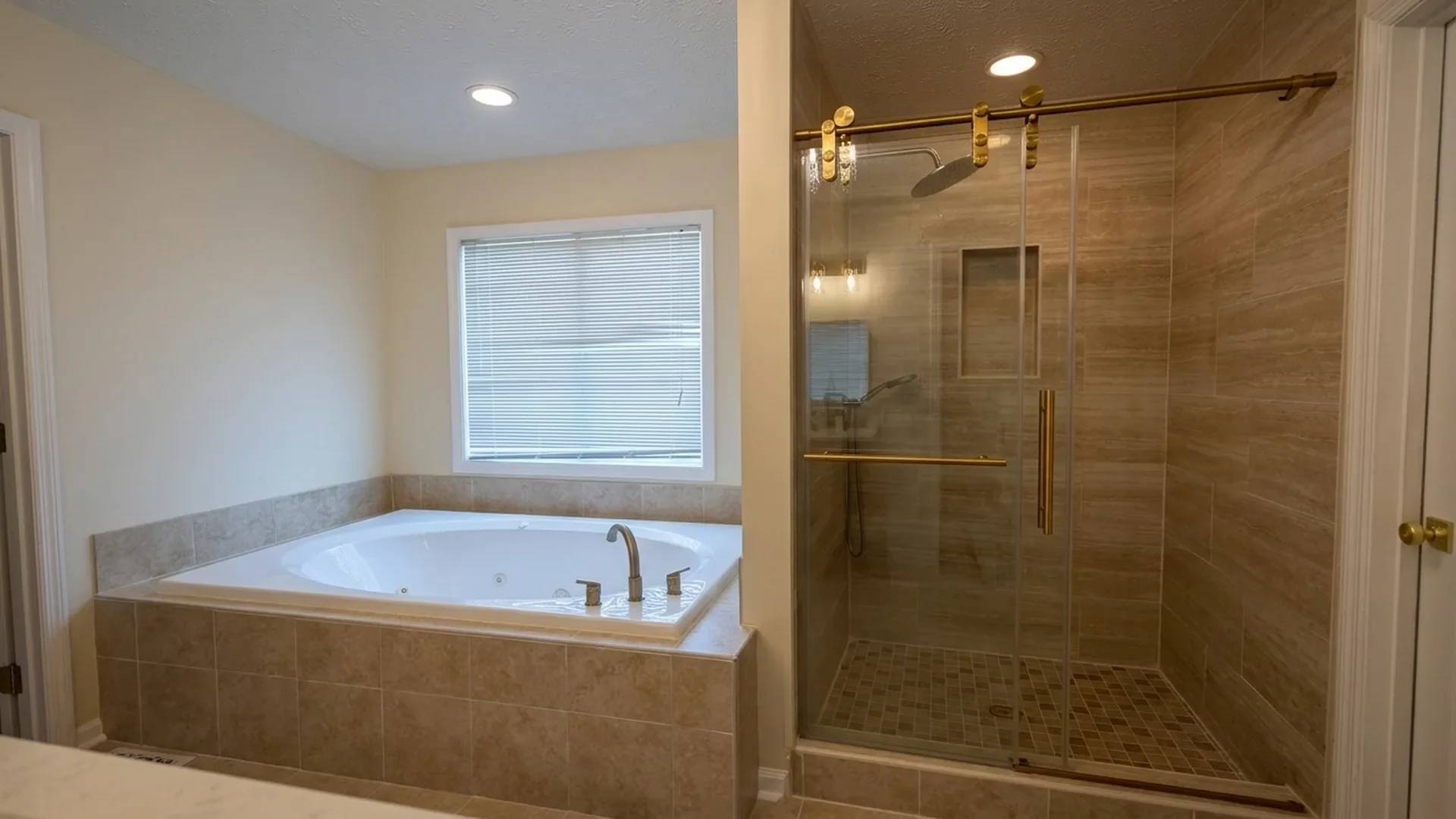 Bathroom with a large bathtub next to a window and a separate walk-in shower with a glass door and brown tile interior.
