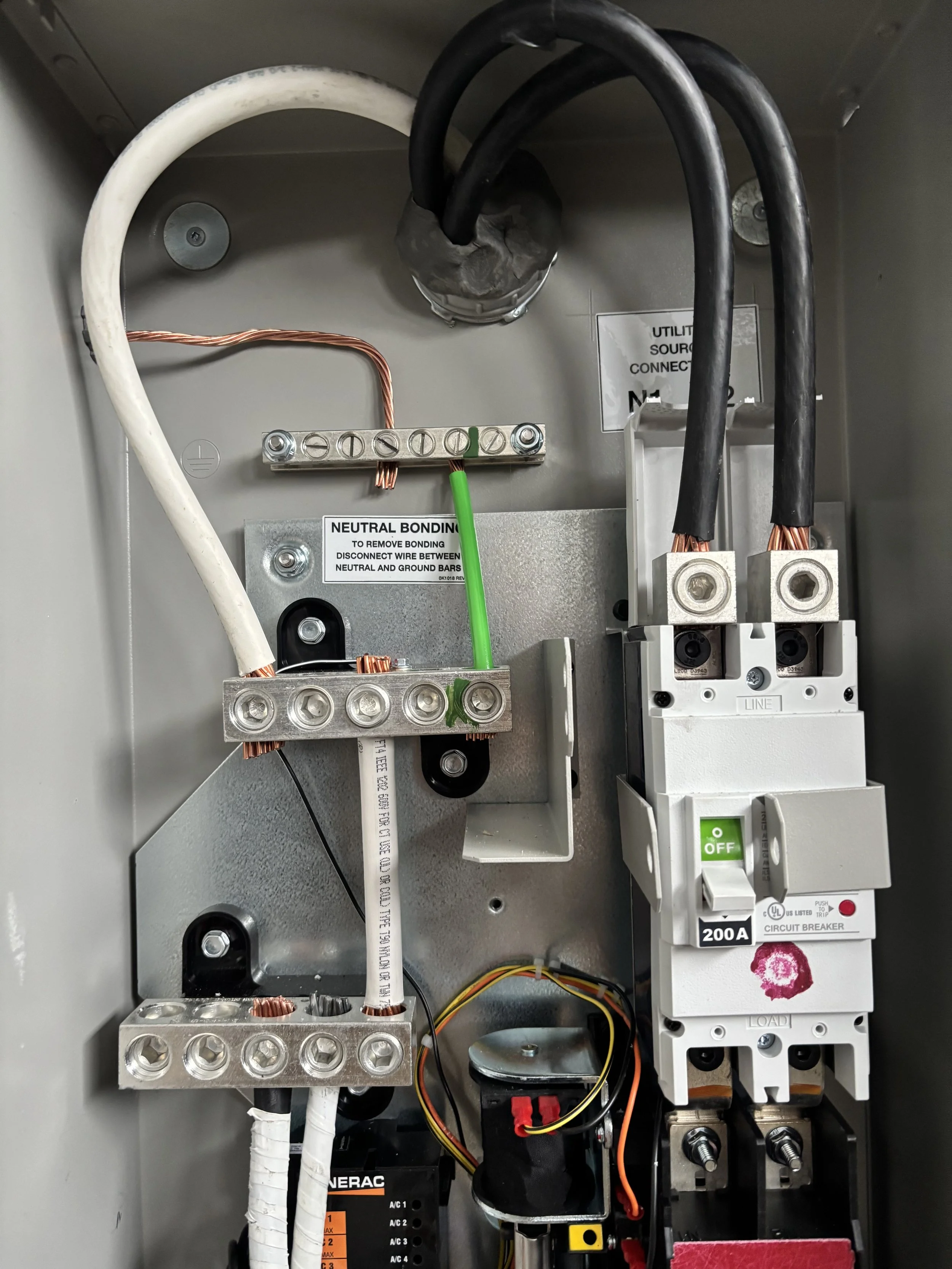 Inside an electrical panel showing wiring, circuit breaker, and electrical components.