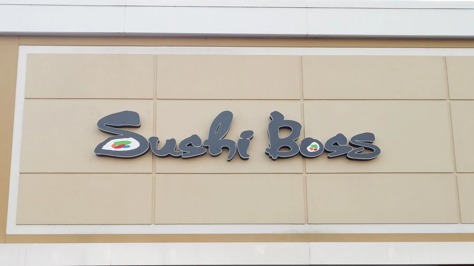 Signage for Sushi Boss with a stylized sushi icon.