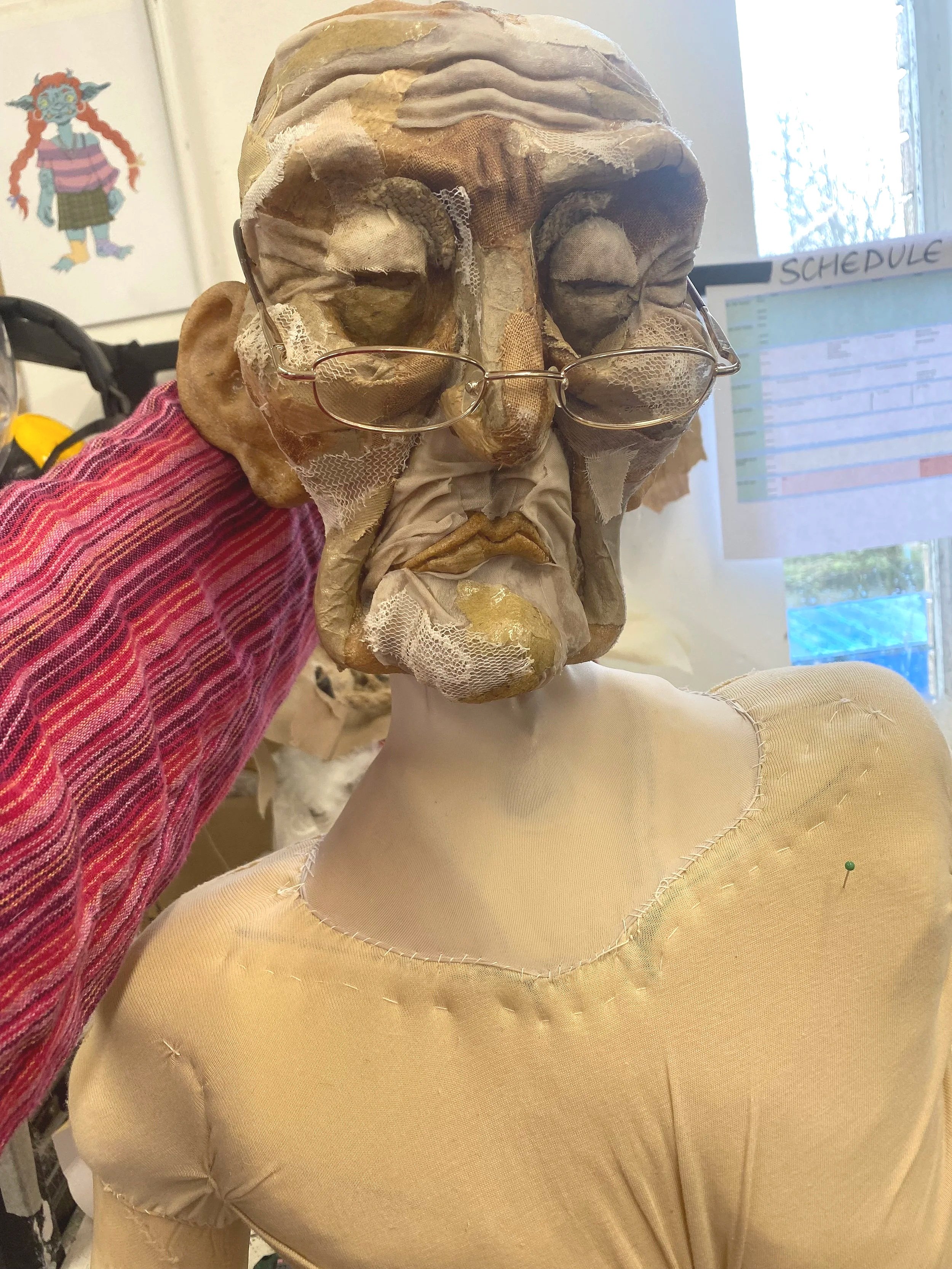 Started patchworking her face with fabric, paper and lace scraps and added a neck made of jersey