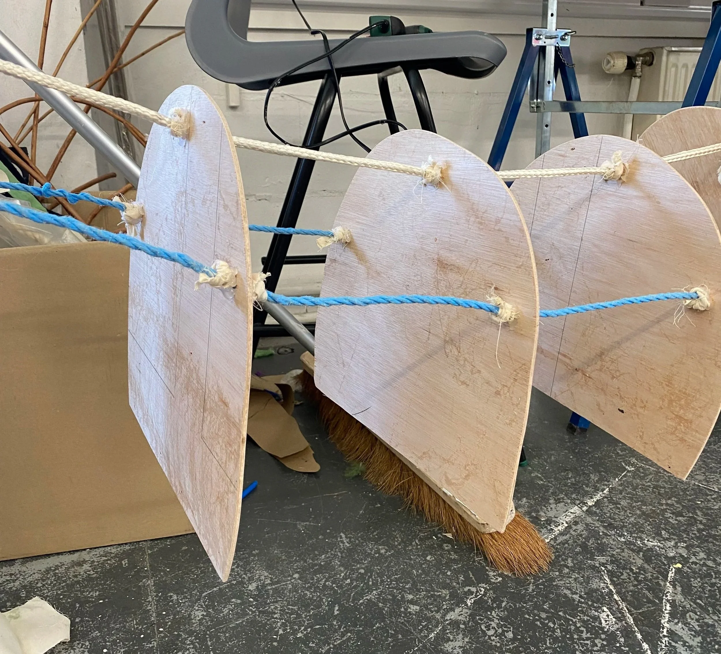 Cut out half circles (gradually decreasing in size) and attached them with rope for the body.