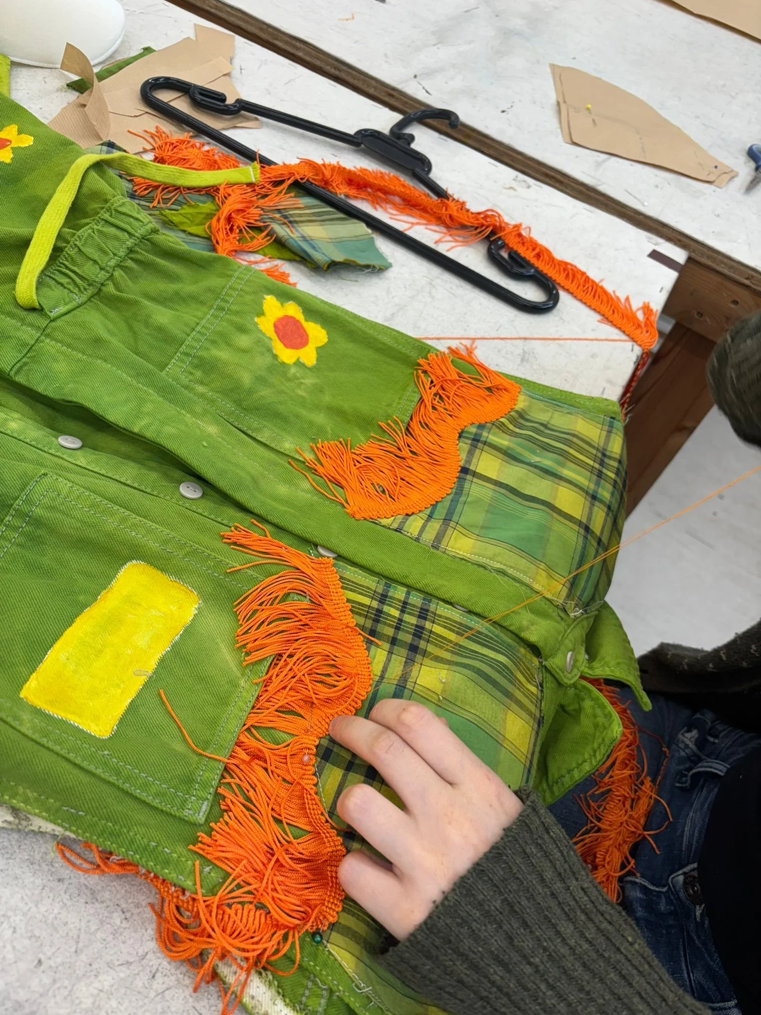 Sewed fringe trim on to some of the bands outfits. Also painted and bedazzled daisies on them.