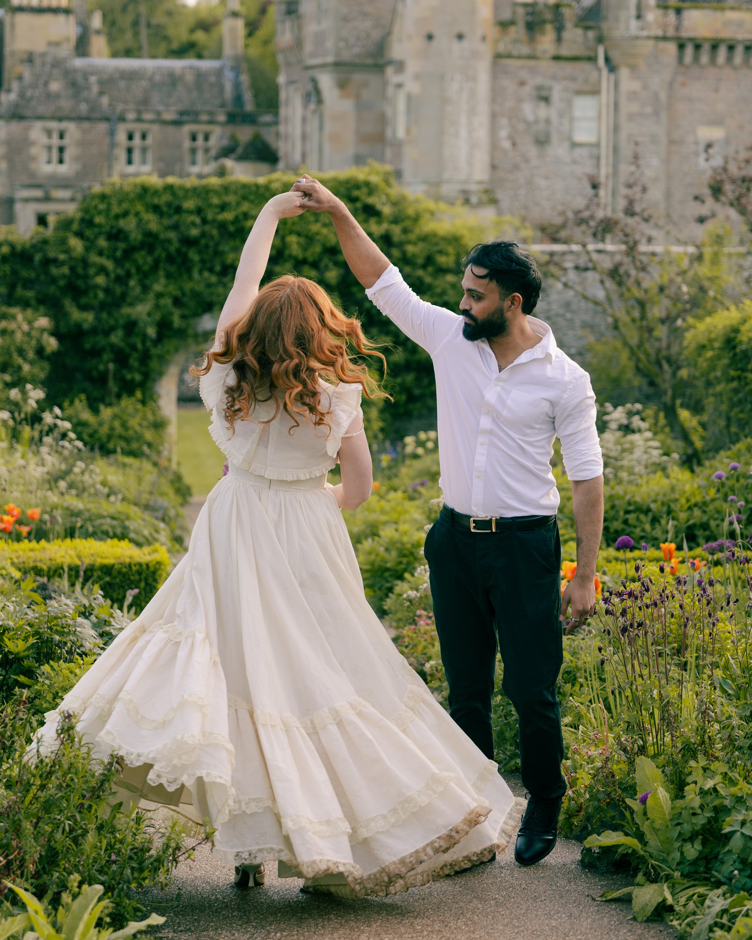 A couple slow dances in front of a castle in Edinburgh, Scotland.