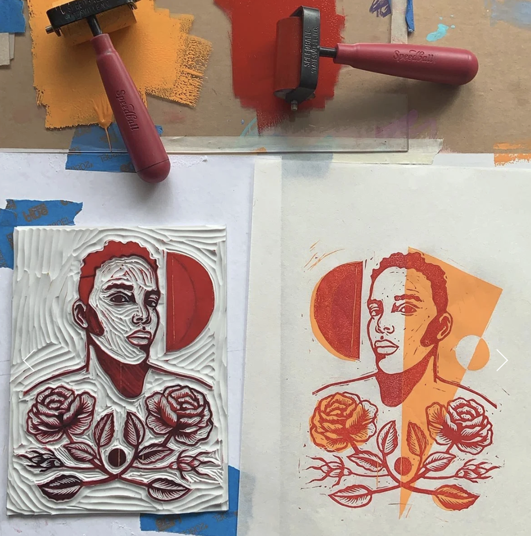 Linocut workshop near Washington, D.C. example. A linocut print of a woman's portrait with roses and a sun in the background. The workspace contains carved linoleum cutters and painted paper.