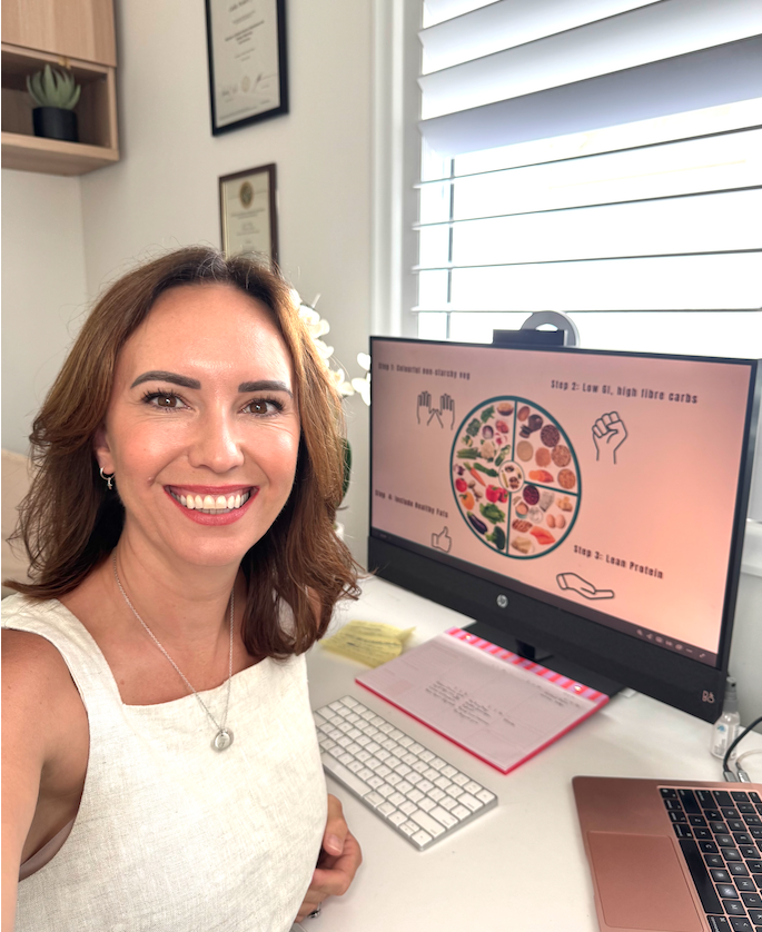 Cailie Ford on a video call, with a balanced plate nutrition diagram displayed on her monitor