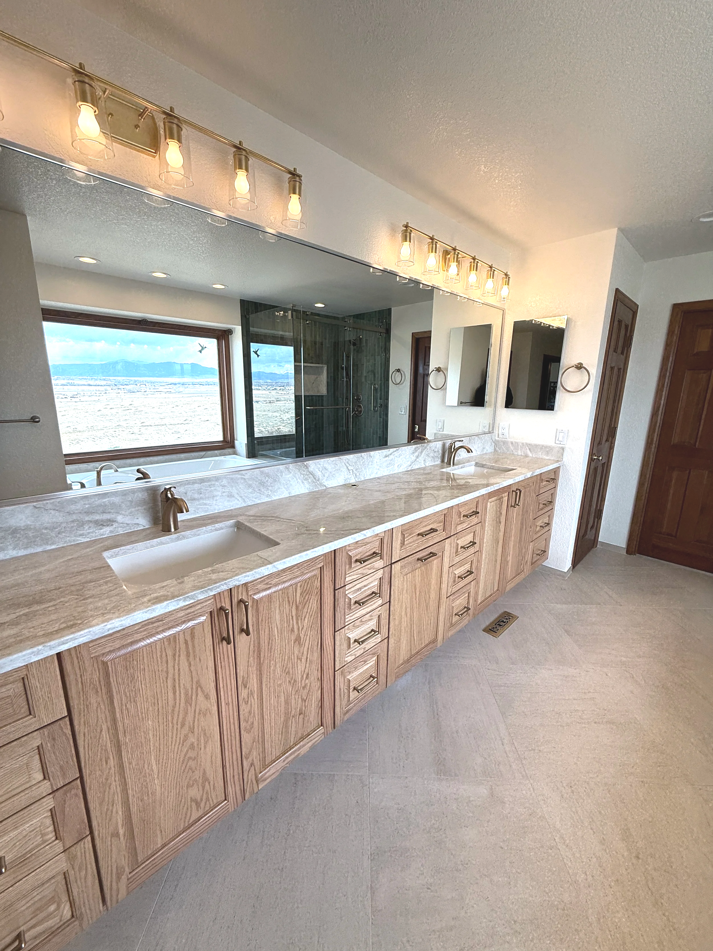 What started as a standard primary bathroom became a show-stopping transformation. By extending their budget, the clients were able to incorporate beautiful upgrades including Taj Mahal quartzite, a custom vanity, detailed tile work, a custom shower 