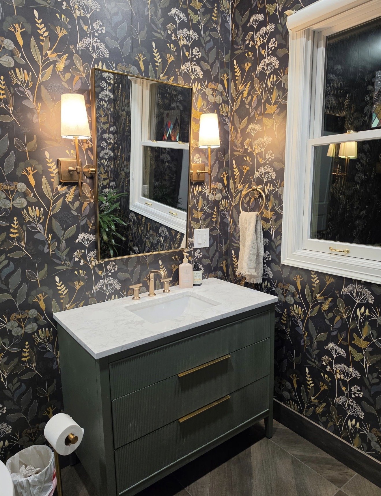 Curated Powder Bath with updated vanity, sconces and wallpaper