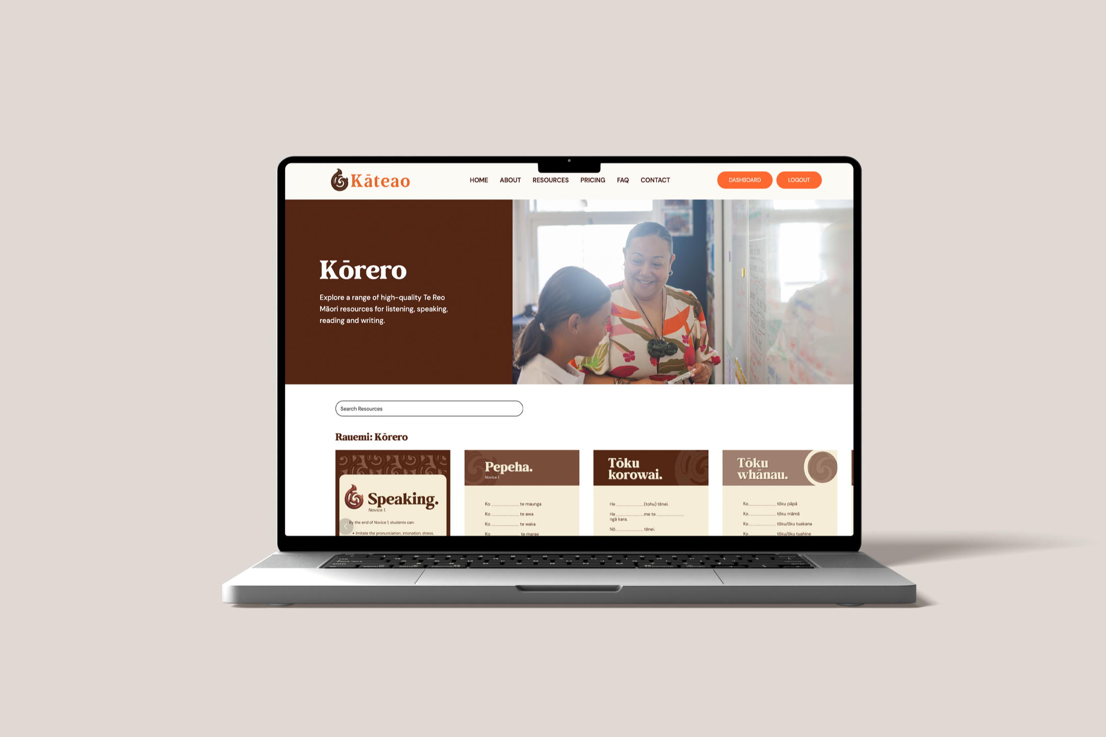 Laptop screen displaying a website about the Māori language, showing a header with navigation, a large image of a teacher and student, and sections with resources for learning the language.