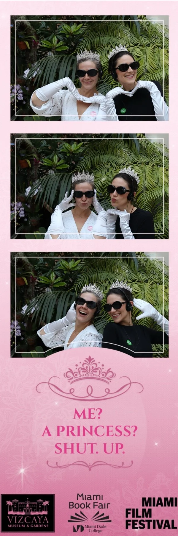 Two women wearing tiaras and sunglasses making fun poses in a photo booth with a green leafy background. The photo booth has three pictures of the women, with the bottom one showing both smiling and the middle showing playful pouts. The booth has a p