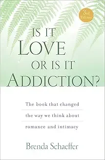 Book cover titled 'Is It Love or Is It Addiction?' by Brenda Schaeffer, featuring a green leafy background and a gold badge indicating third edition. For women healing trauma, anxious attachment and love addiction and codependency.