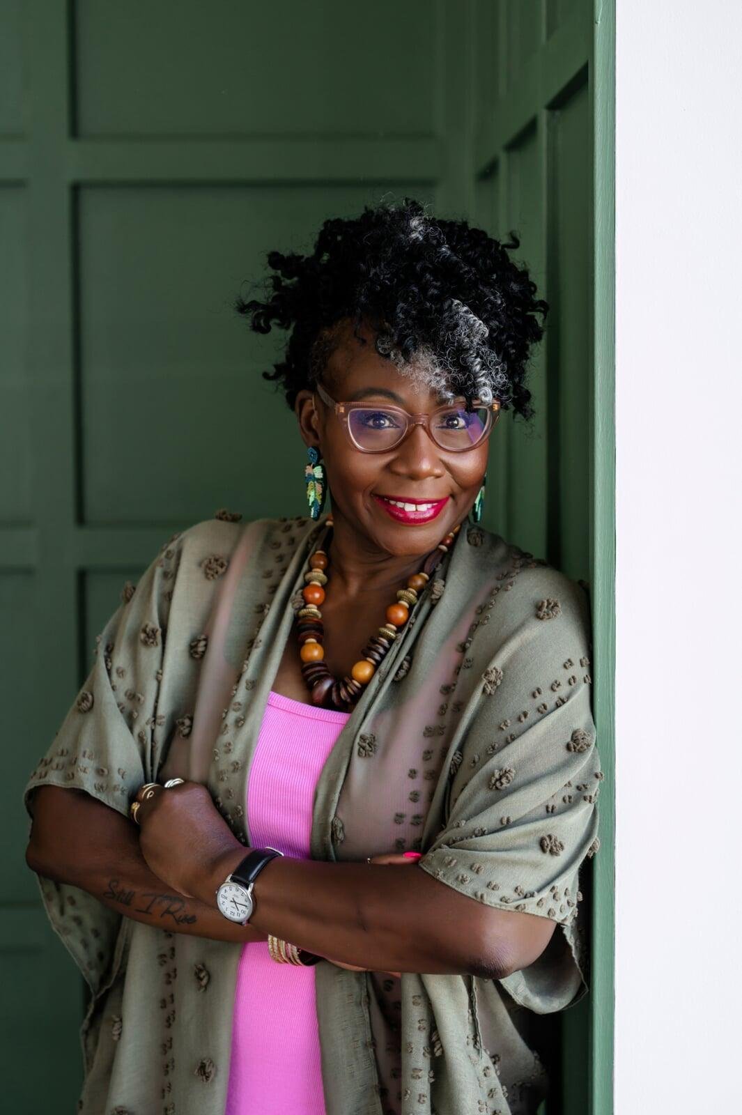 Robrenna, founder of Reclaiming HER Resilience, a Black woman trauma-informed story work coach, smiling warmly