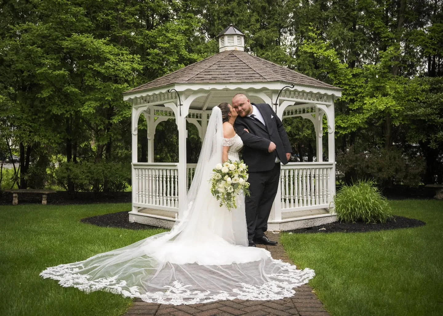 A picture-perfect moment tucked beneath our charming garden gazebo 🤍✨

Surrounded by lush greenery and timeless elegance, this sweet kiss captures everything we love about outdoor ceremonies&mdash;romance, intimacy, and a touch of storybook magic. T