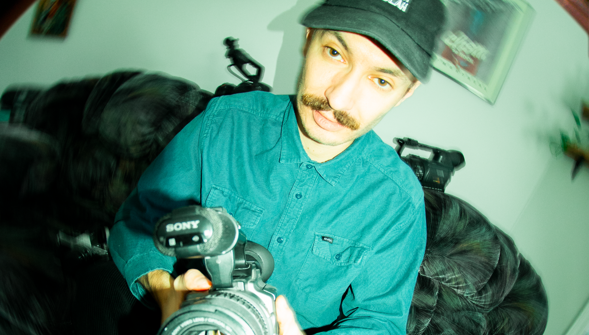 canadian filmer man blue shirt black hate video cameras skateboarding
