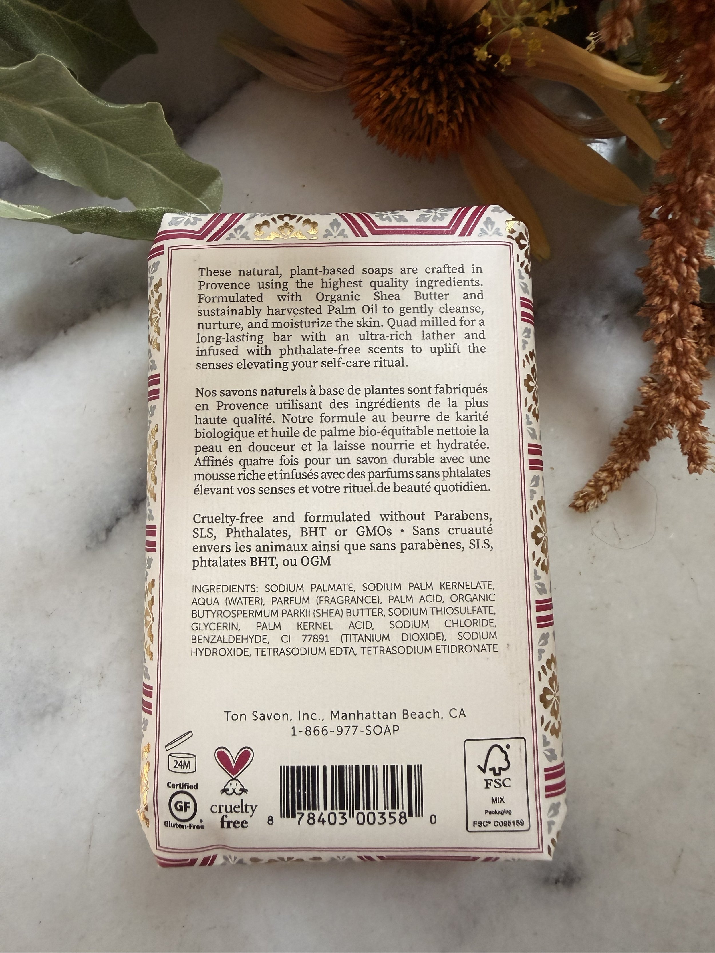 Back of Terre à Terre Black Cherry Soap with flowers on marble