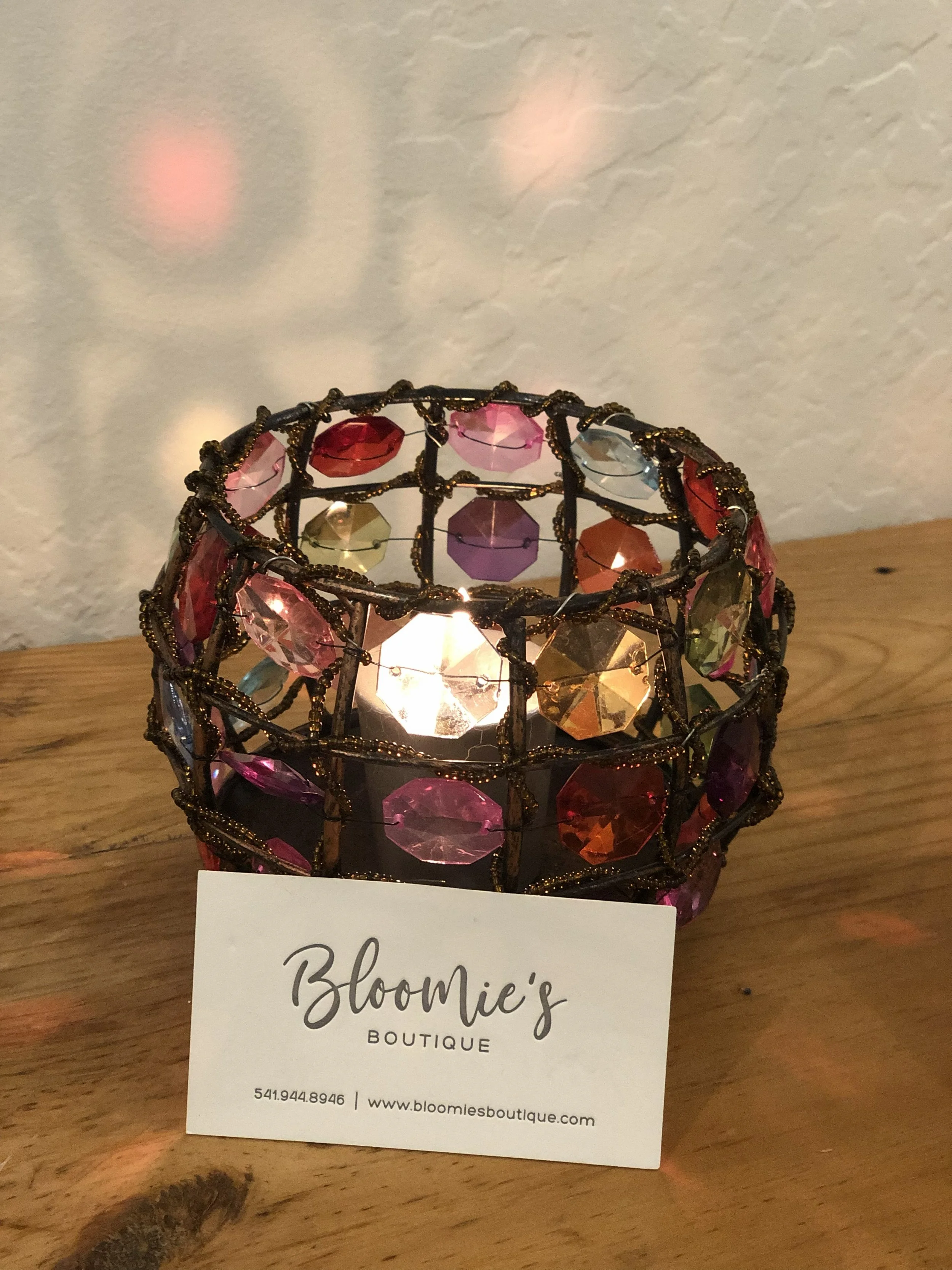 Colorful candle holder decor with Bloomie's Boutique business card on front counter. (Photo credit: Melissa Mitchell-Hooge)