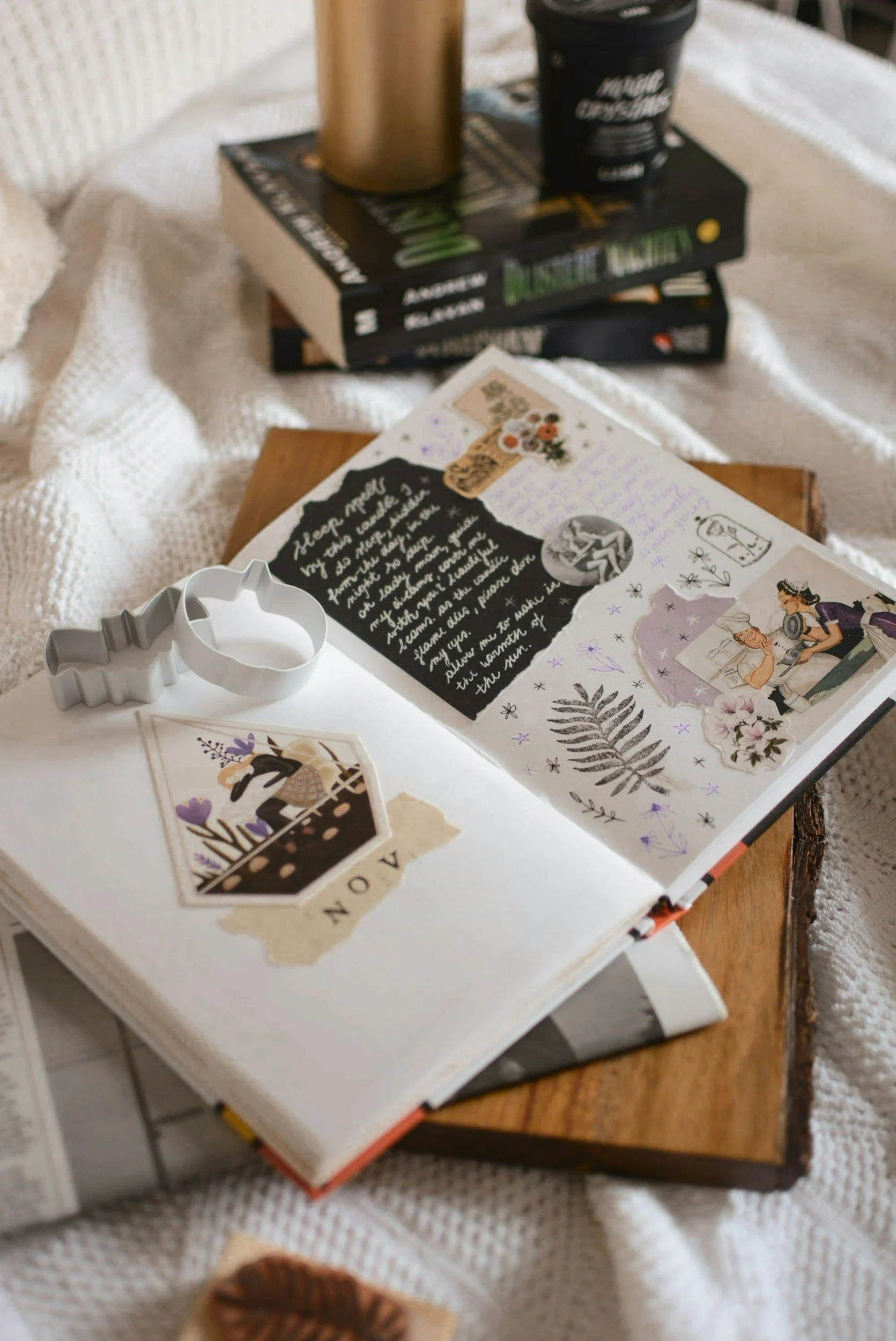 Open junk journal with two books in the background. (Photo credit: Estée Janssens)