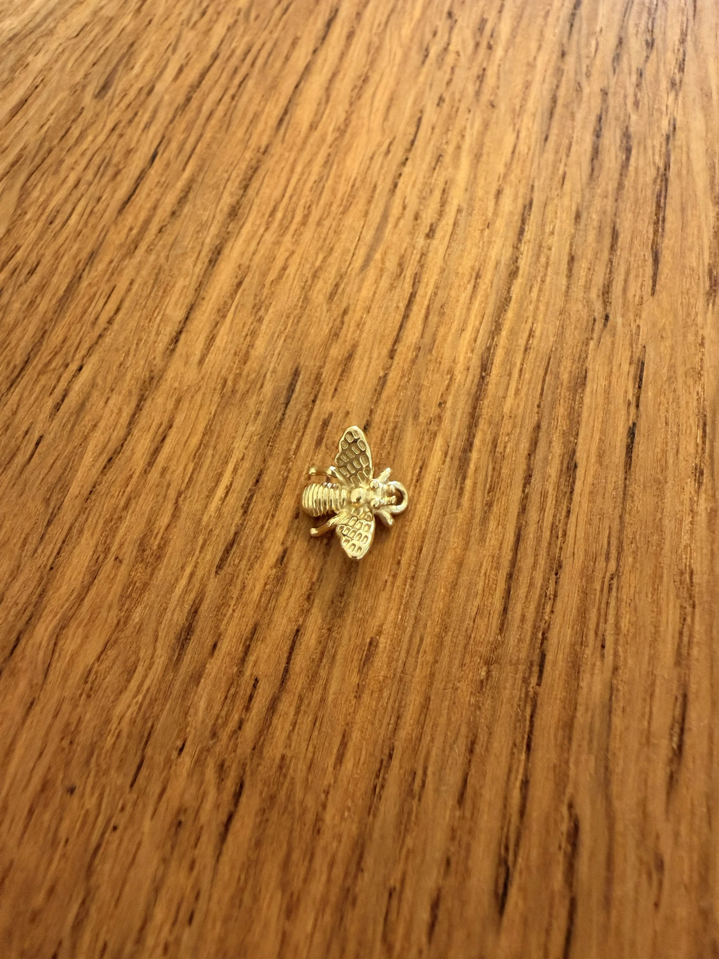 Bumble Bee Charm by House of Azelea on wood countertop