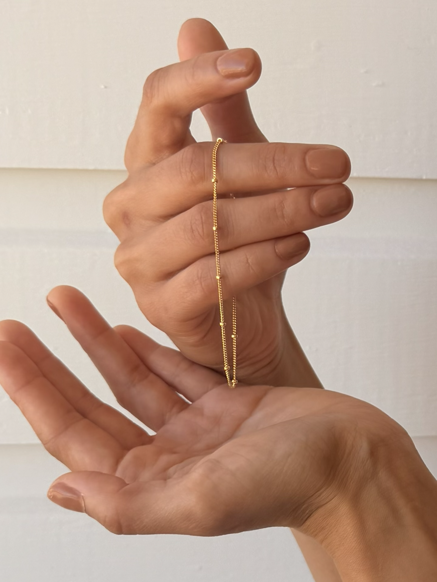 Delicate Ball Chain Bracelets by Katie Waltman Jewelry displayed in model's hands