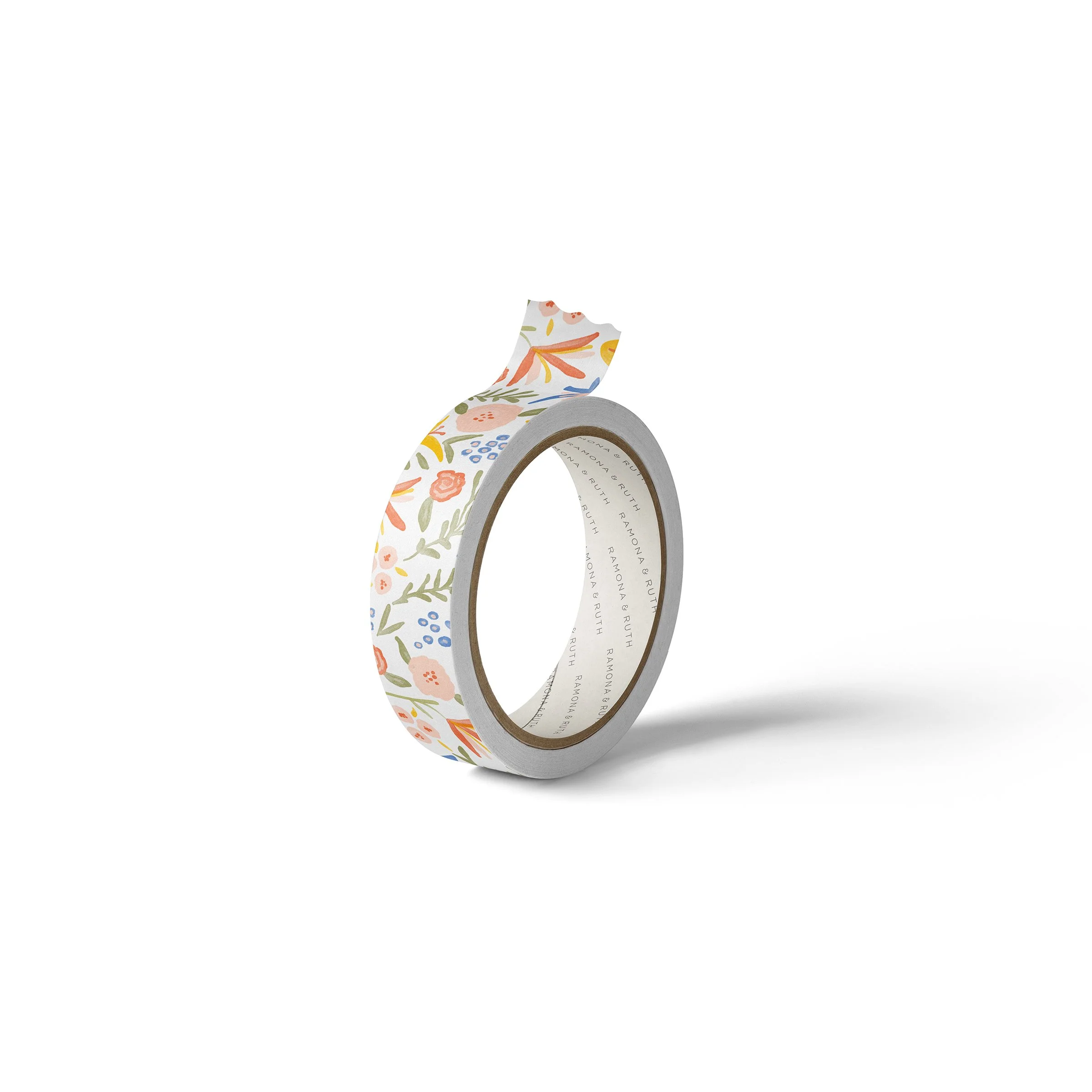 One roll of Ramona & Ruth's Spicy Floral Washi Tape laying on edge with white background