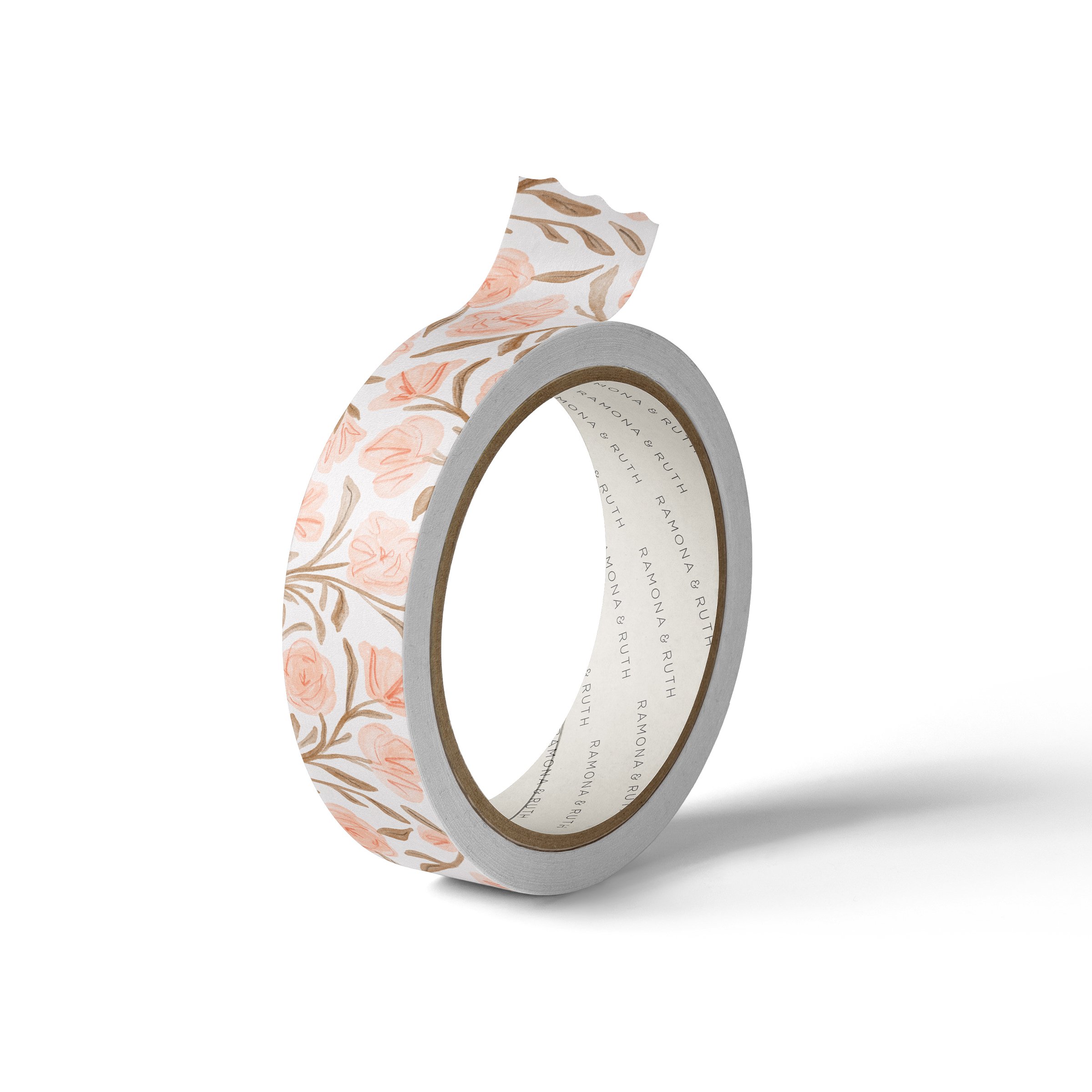 One roll of Ramona & Ruth's Pink Floral Washi Tape on edge with white background