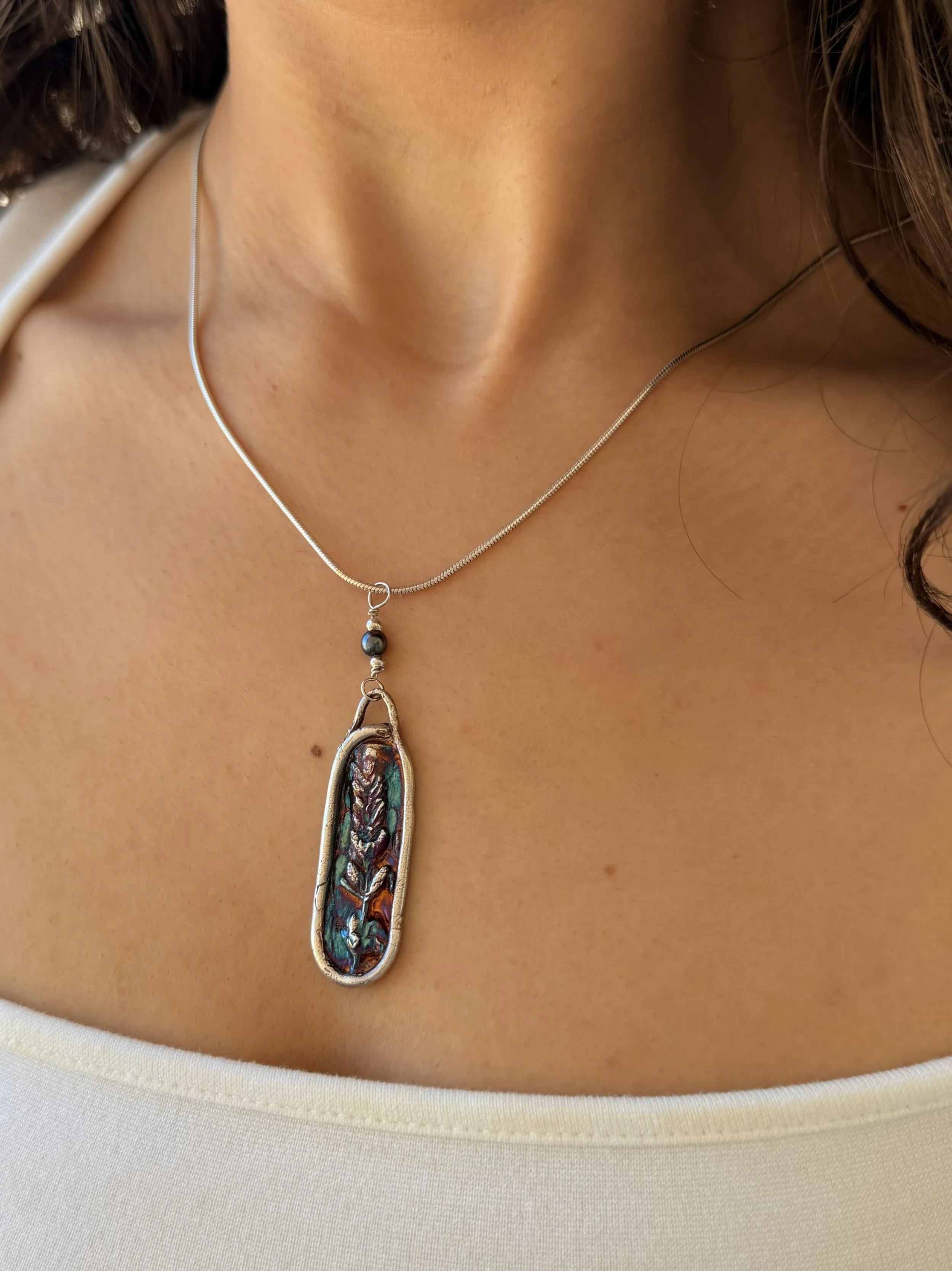 Tucci'Z Designs fine silver pendant with lavender design on sterling silver necklace worn by model and available at Bloomie's Boutique