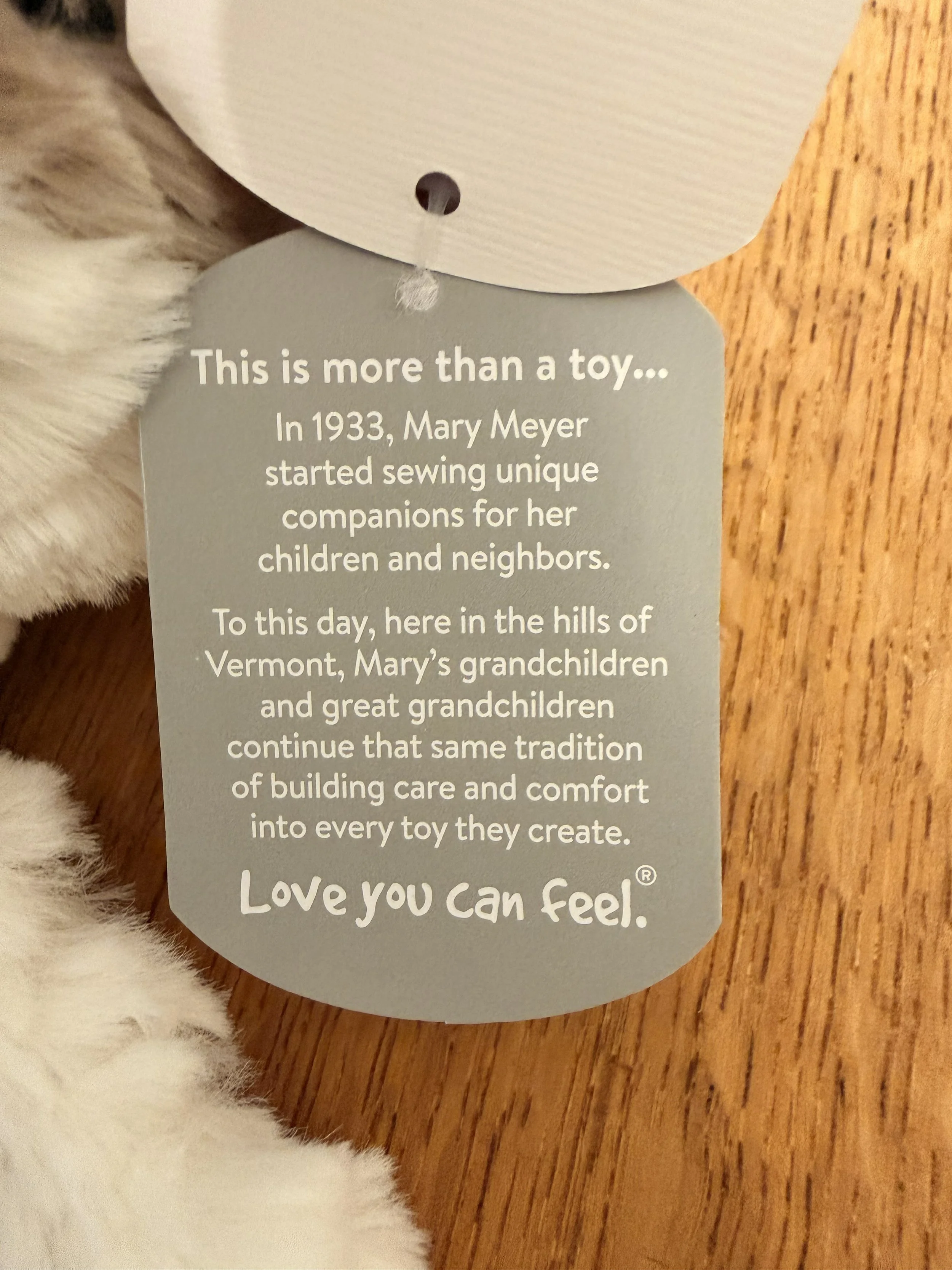 Close-up of Mary Meyer tag on Putty Nursery Giraffe stuffed animal toy