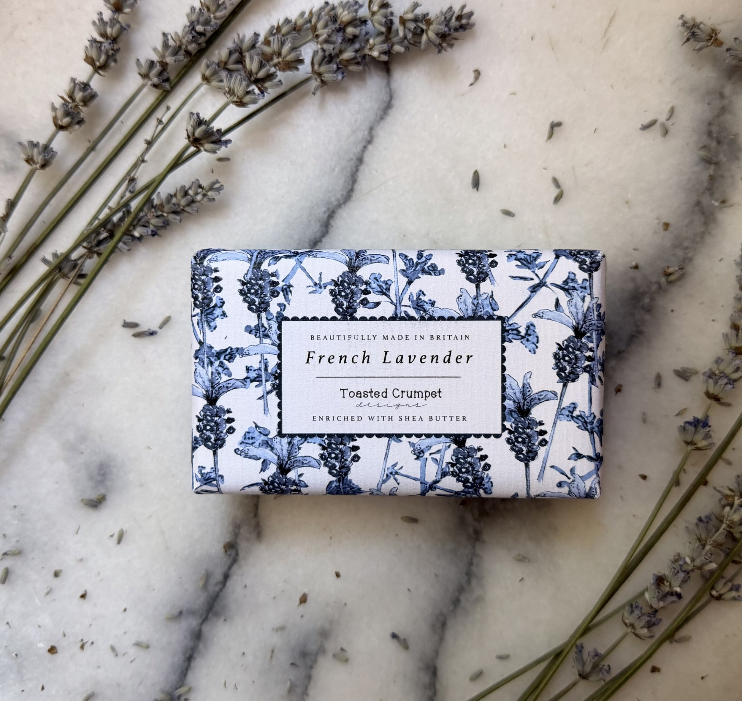 Front of Toasted Crumpet's French Lavender Soap on marble with dried lavender flowers