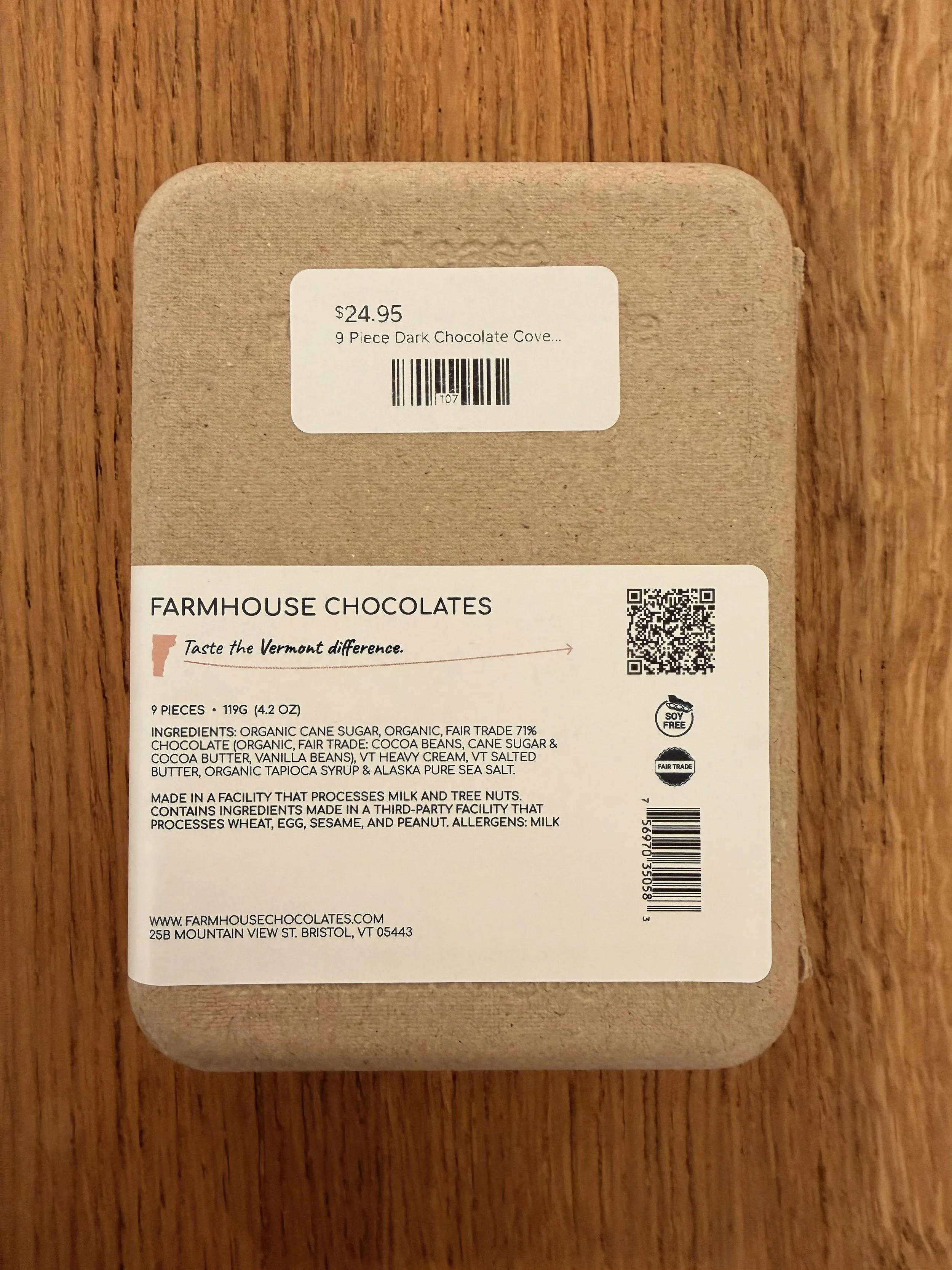 Back of Farmhouse Chocolates' 9-Piece Dark Chocolate Salted Caramels on wood countertop