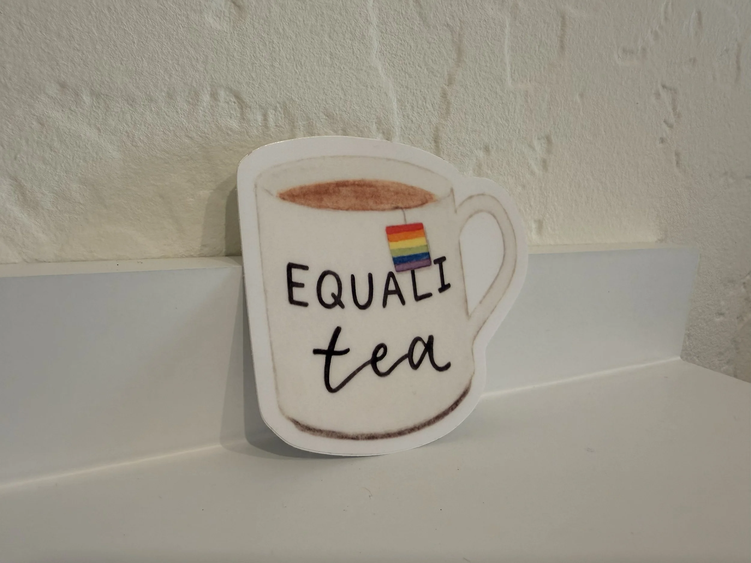 One Equali-Tea Vinyl Sticker on white shelf