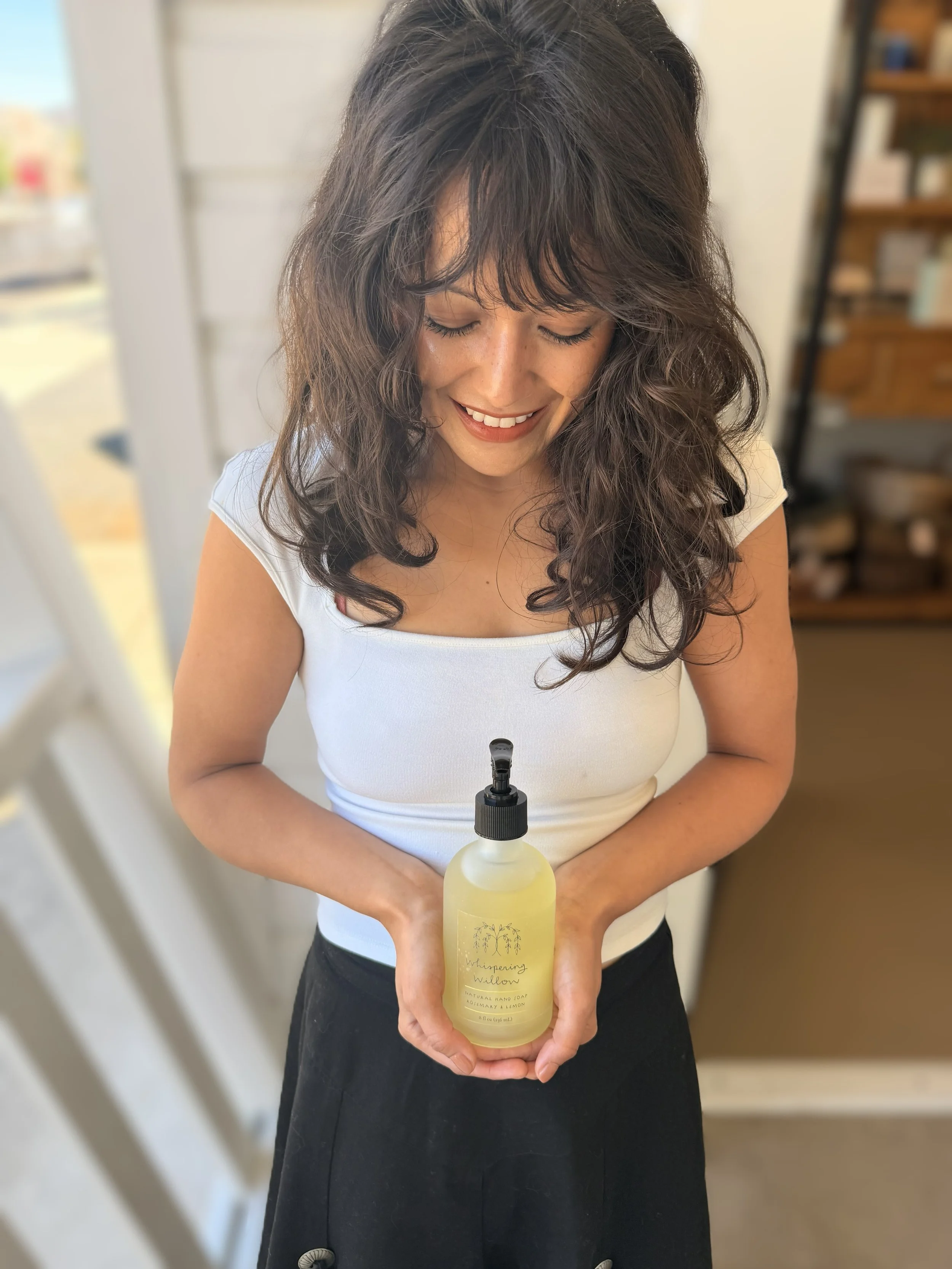 Whispering Willow Rosemary Lemon Pump Hand Soap with model holding bottle