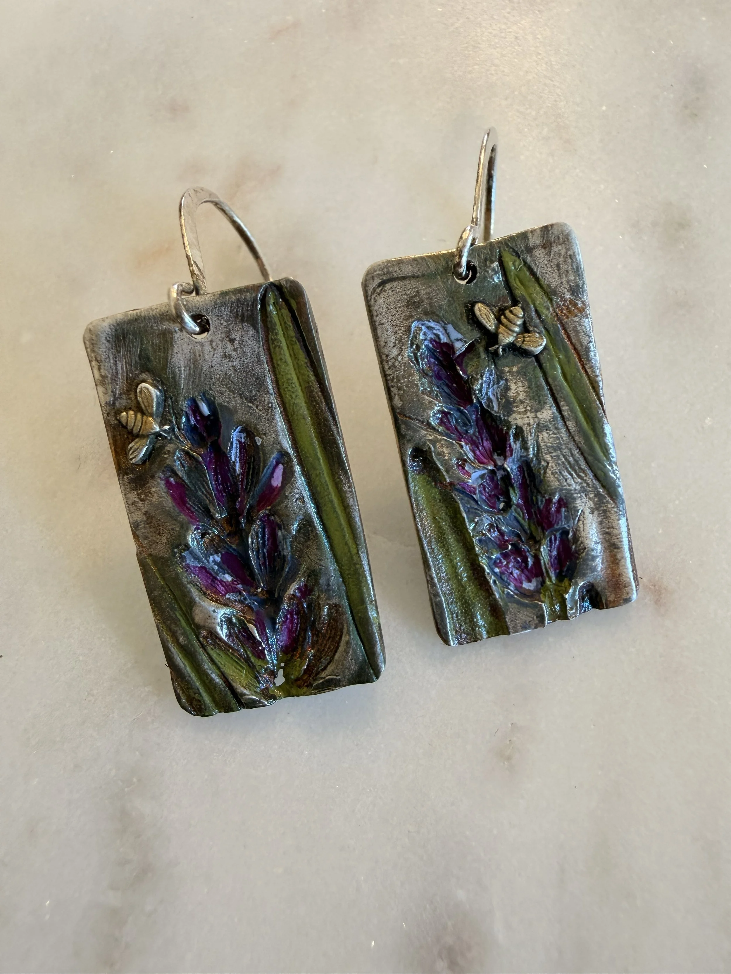 Close up of Tucci'Z Designs Fine Silver Lavender & Bees Earrings on white marble