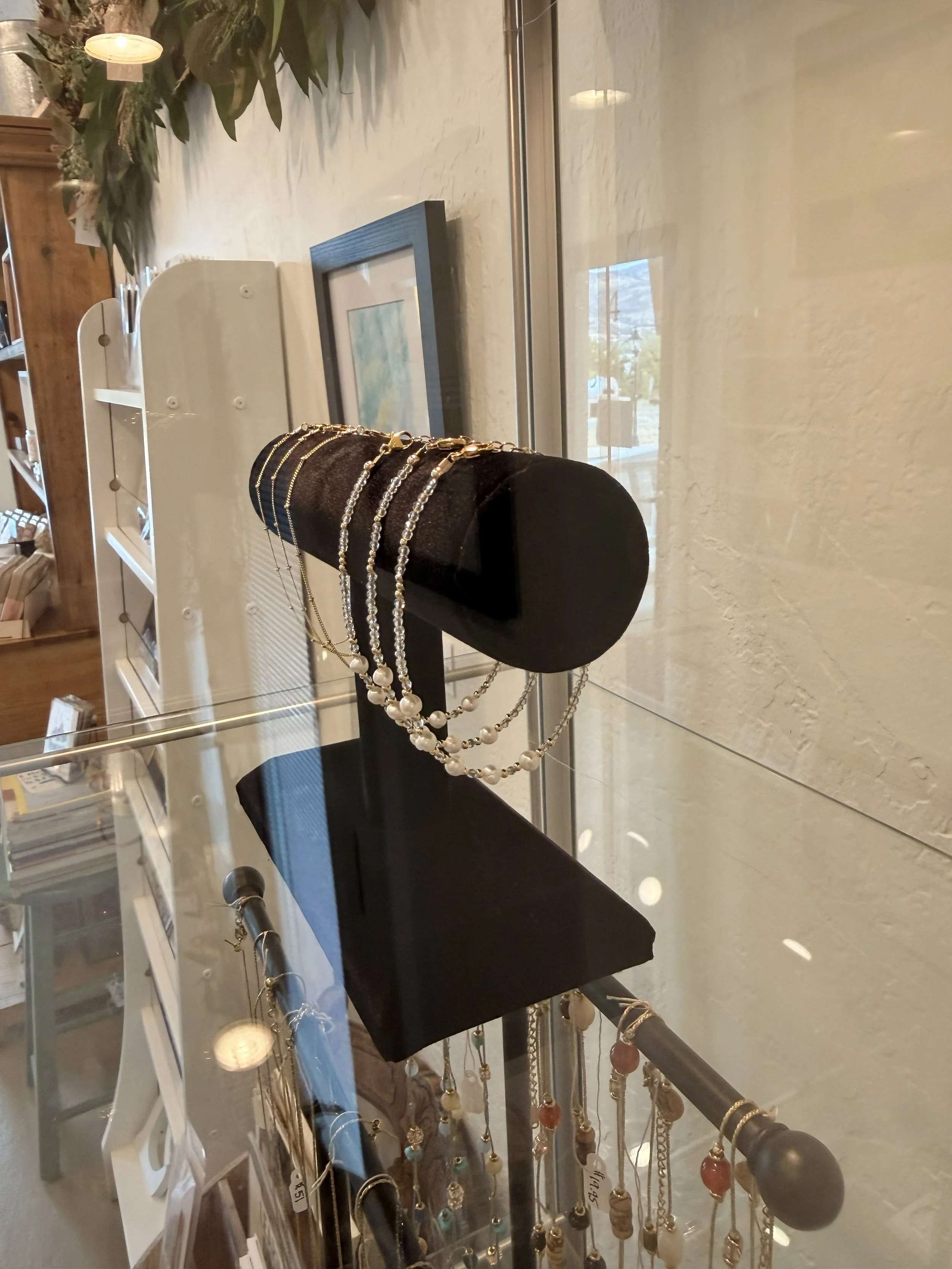 Golden Sands Bracelets by Katie Waltman Jewelry on display at Bloomie's Boutique with Delicate Ball Chain Bracelets by Katie Waltman Jewelry in the background