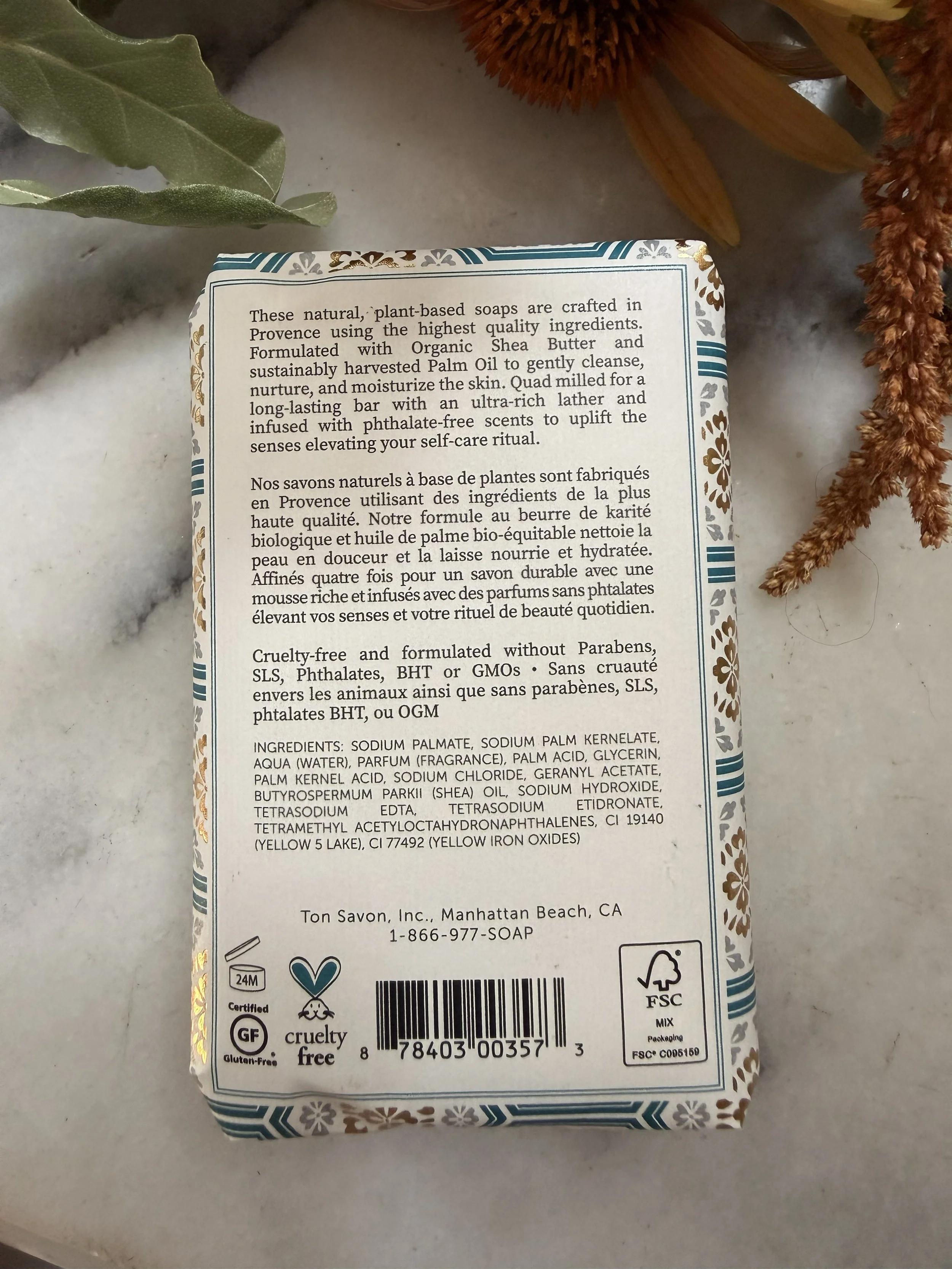 Back of Terre á Terre French Pear Soap with flowers on marble