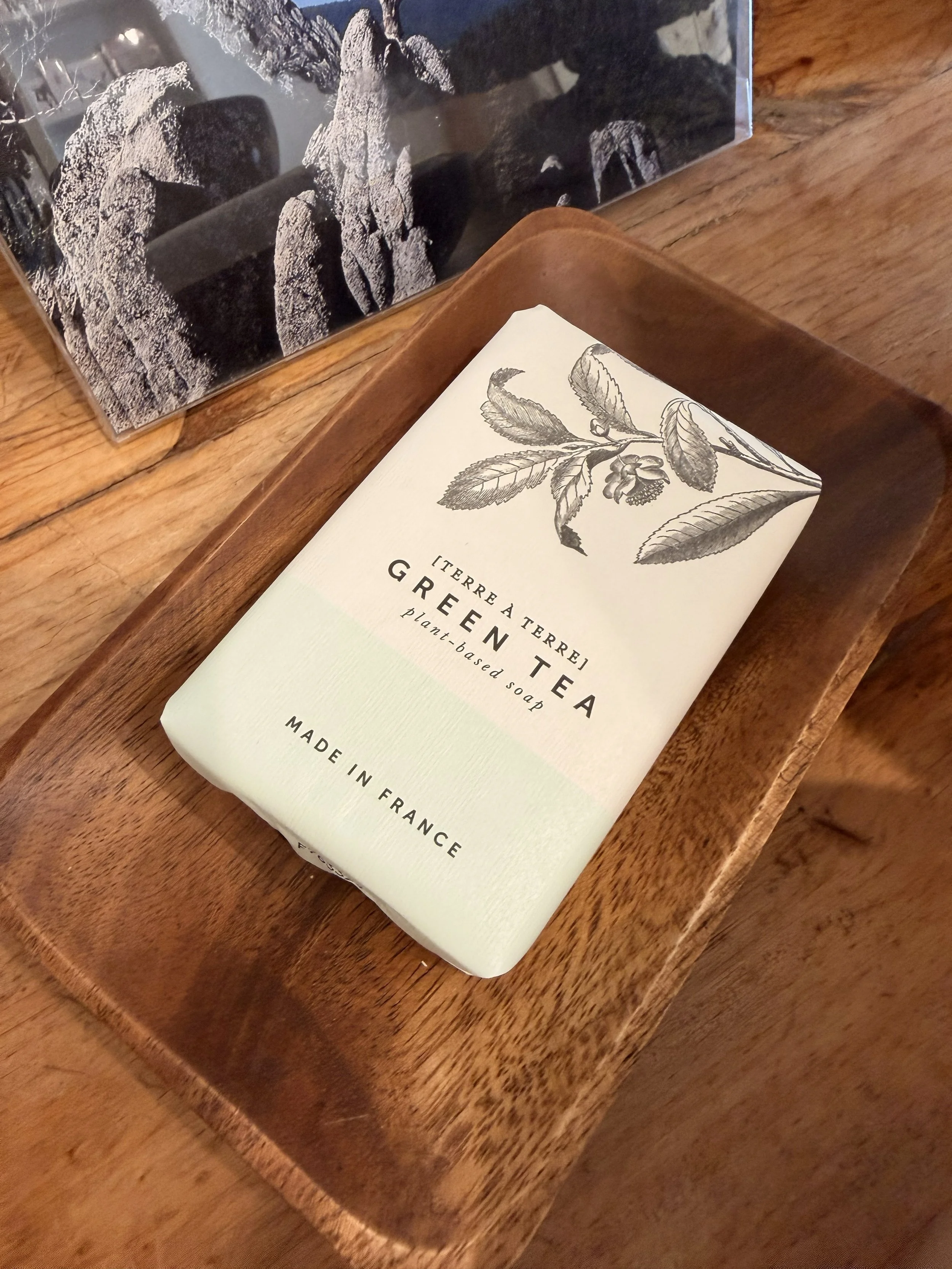 Top view of Terre á Terre Green Tea Soap in wood display dish