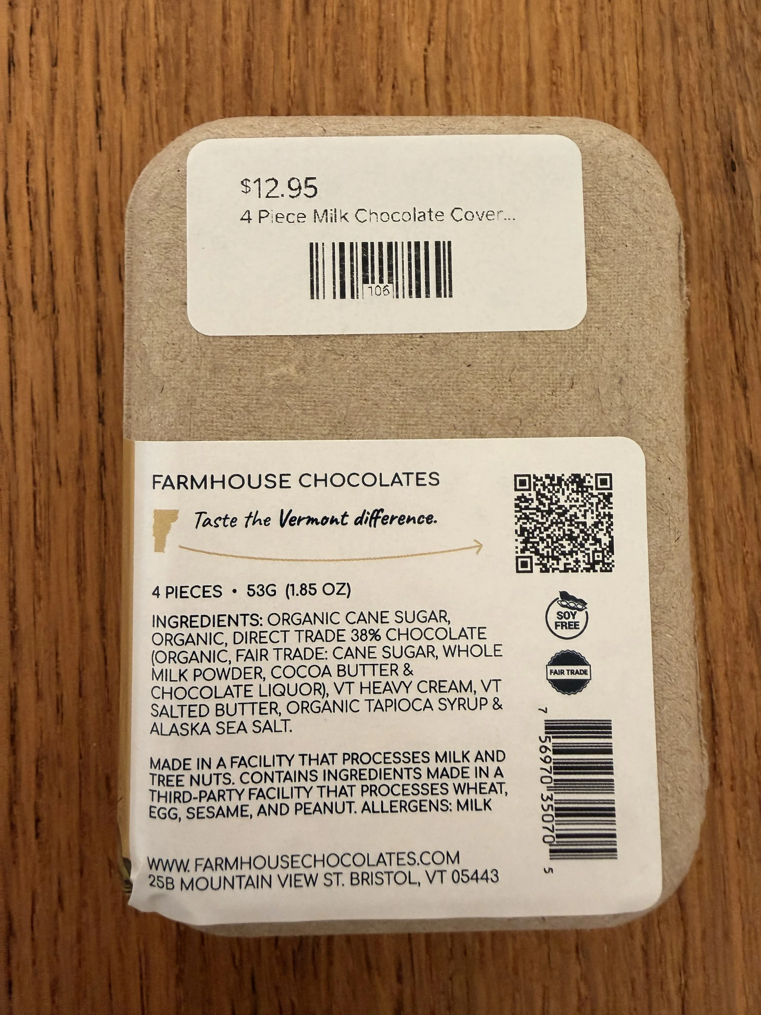 Back of Farmhouse Chocolates' 4-Piece Milk Chocolate Salted Caramels recycled paper box on wood countertop