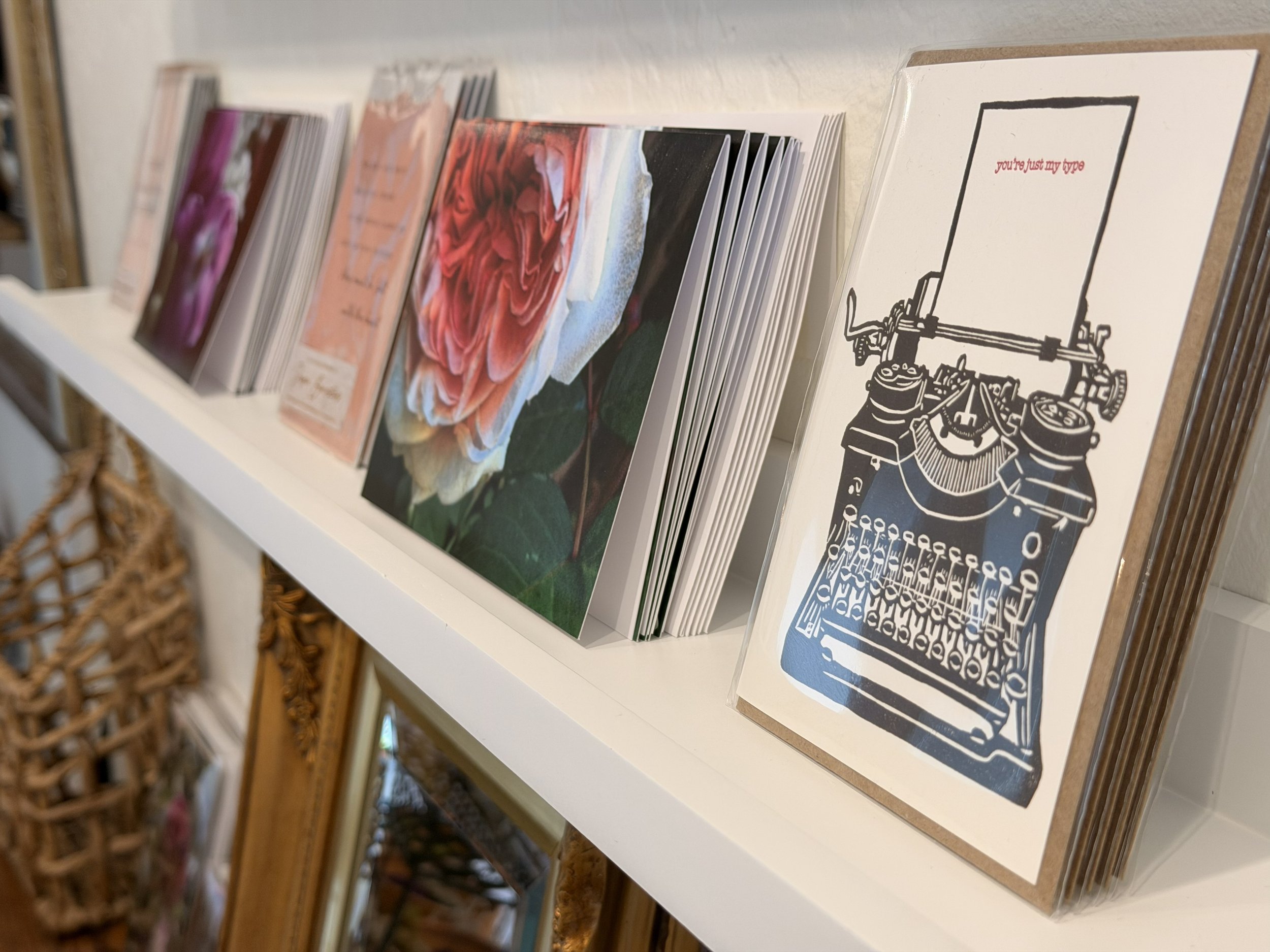 Greeting cards on shelf at Bloomie's Boutique