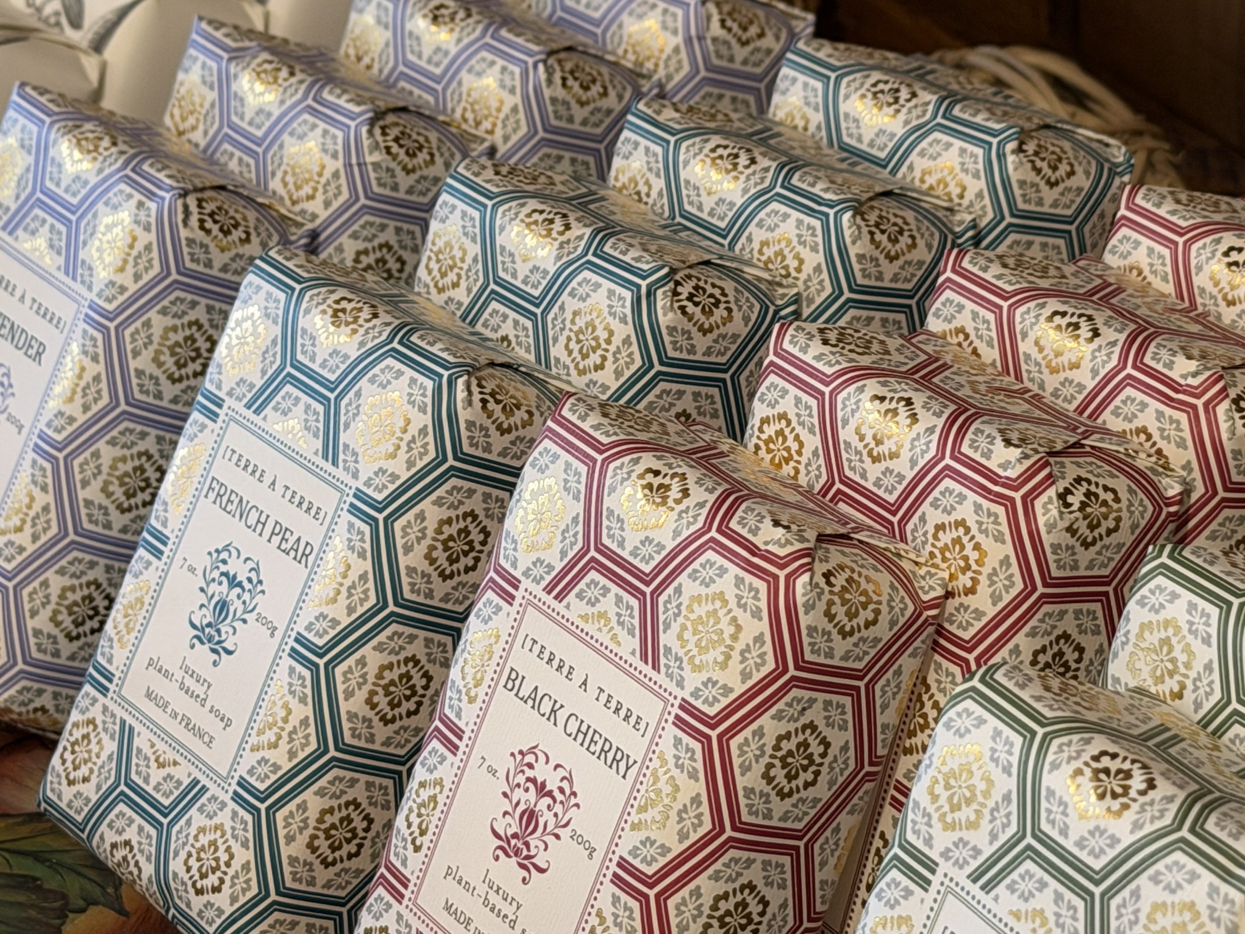 Multiple Terre à Terre Black Cherry Soaps on display with Terre à Terre French Pear Soaps at Bloomie's Boutique
