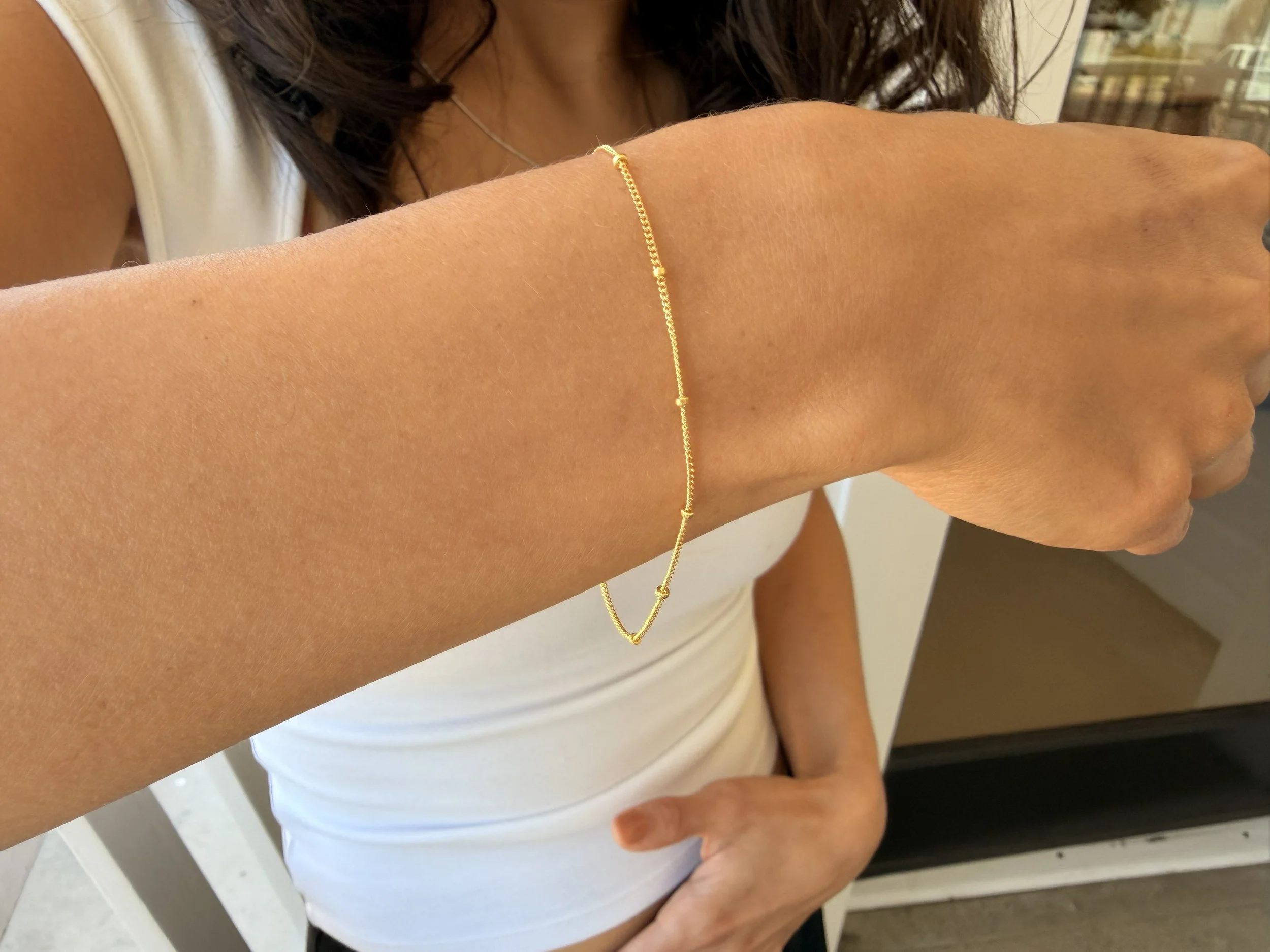 Delicate Ball Chain Bracelets by Katie Waltman Jewelry on model's wrist