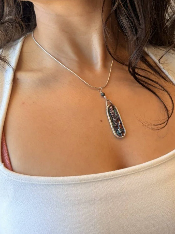 Tucci'Z Designs fine silver pendant with lavender design on sterling silver necklace worn by model and available at Bloomie's Boutique